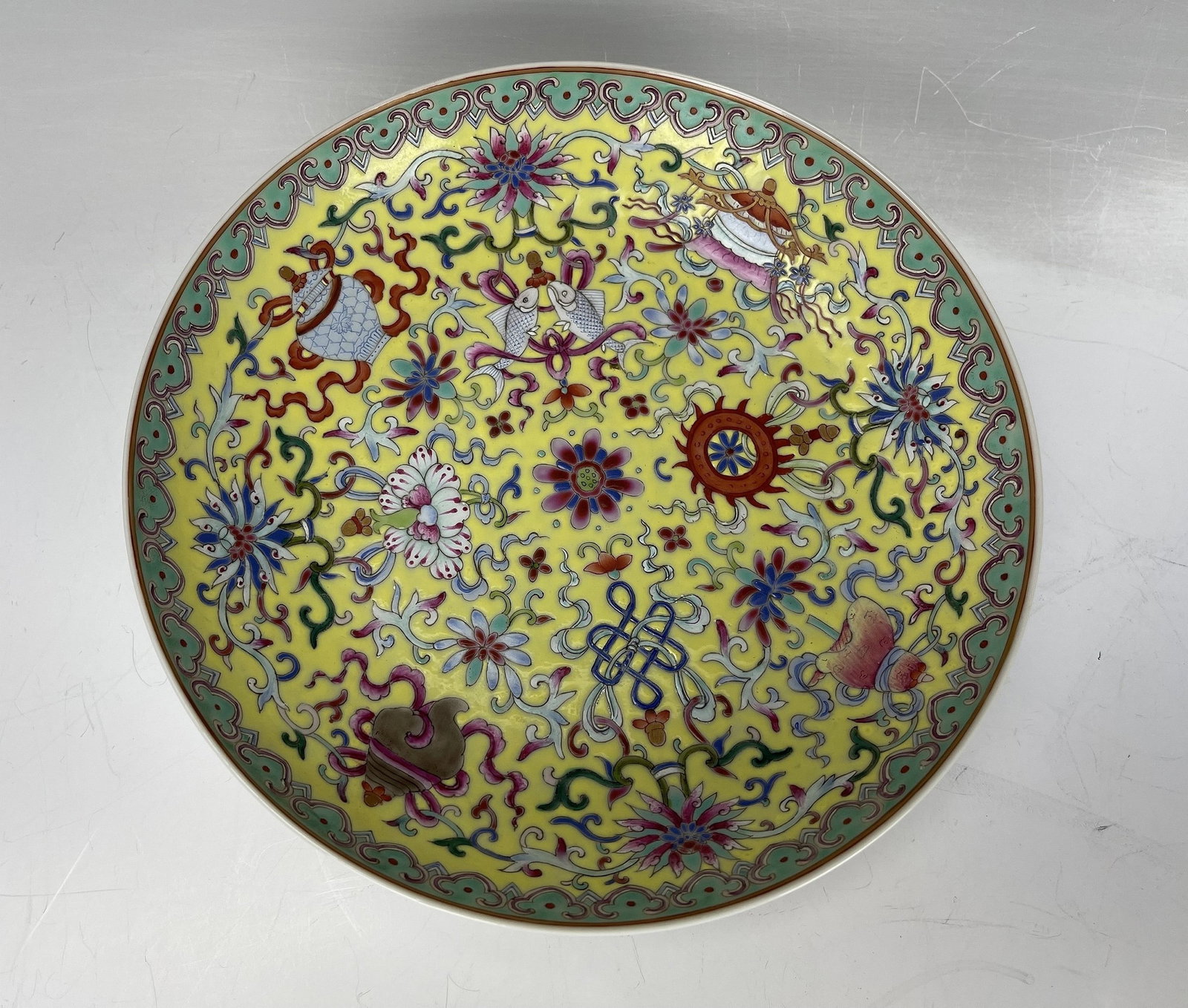 Famille Rose Porcelain Plate with Buddhist Emblems Qianlong Mark: Famille rose plate with Buddhist 8 Emblems on yellow ground, Qianlong mark. D 21 cm(8.3 in.). Preview from Aug. 26th to 30th from 1:00 PM TO 5:00 PM Eastern Time, Location: 15229 Display Court, Rockvi