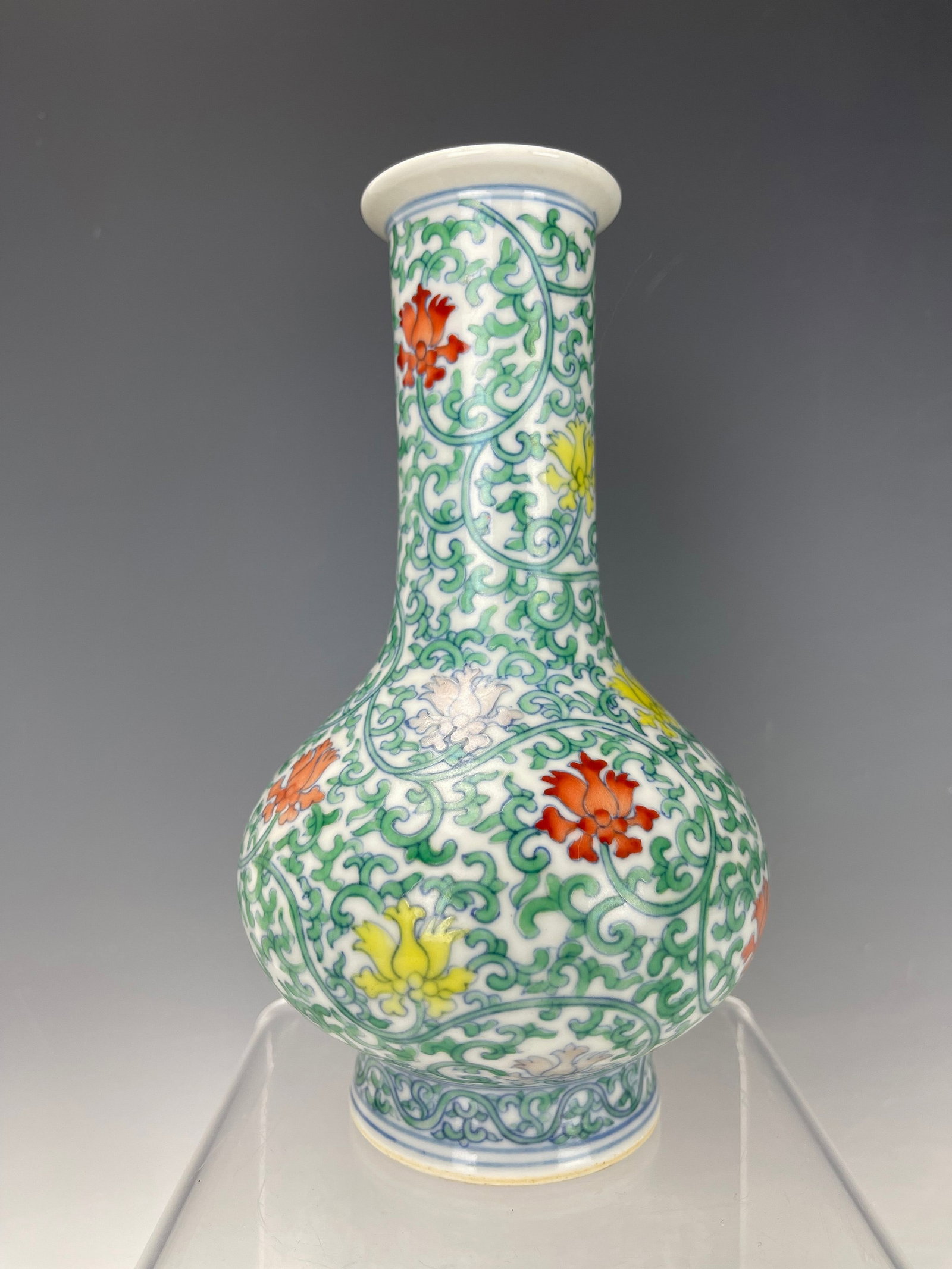 Chinese Doucai Enameled Porcelain Vase Qianlong Mark: Chinese Doucai Enameled Porcelain Vase with long neck painted with scrolling flowers, Qianlong mark, H 19 cm(7.5 in.). Preview from Aug. 26th to 30th from 1:00 PM TO 5:00 PM Eastern Time, Location: 15