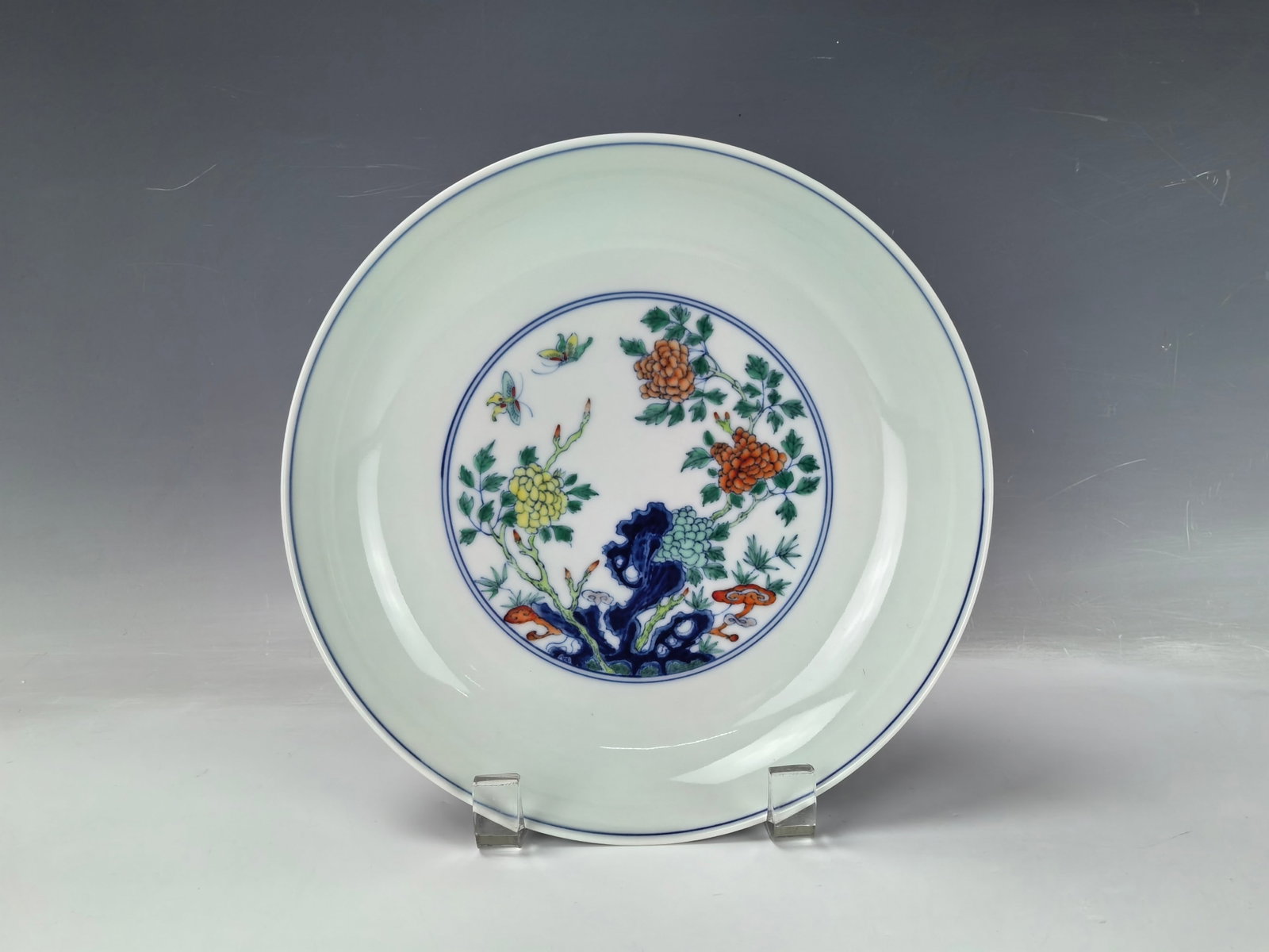 Chinese Doucai Porcelain Plate with Rocks Trees and Flowers Qianlong Mark: Doucai enameled plate painted with rocks, trees and flowers, Qianlong mark,D 21 cm(8.4 in.). Preview from Aug. 26th to 30th from 1:00 PM TO 5:00 PM Eastern Time, Location: 15229 Display Court, Rockvil