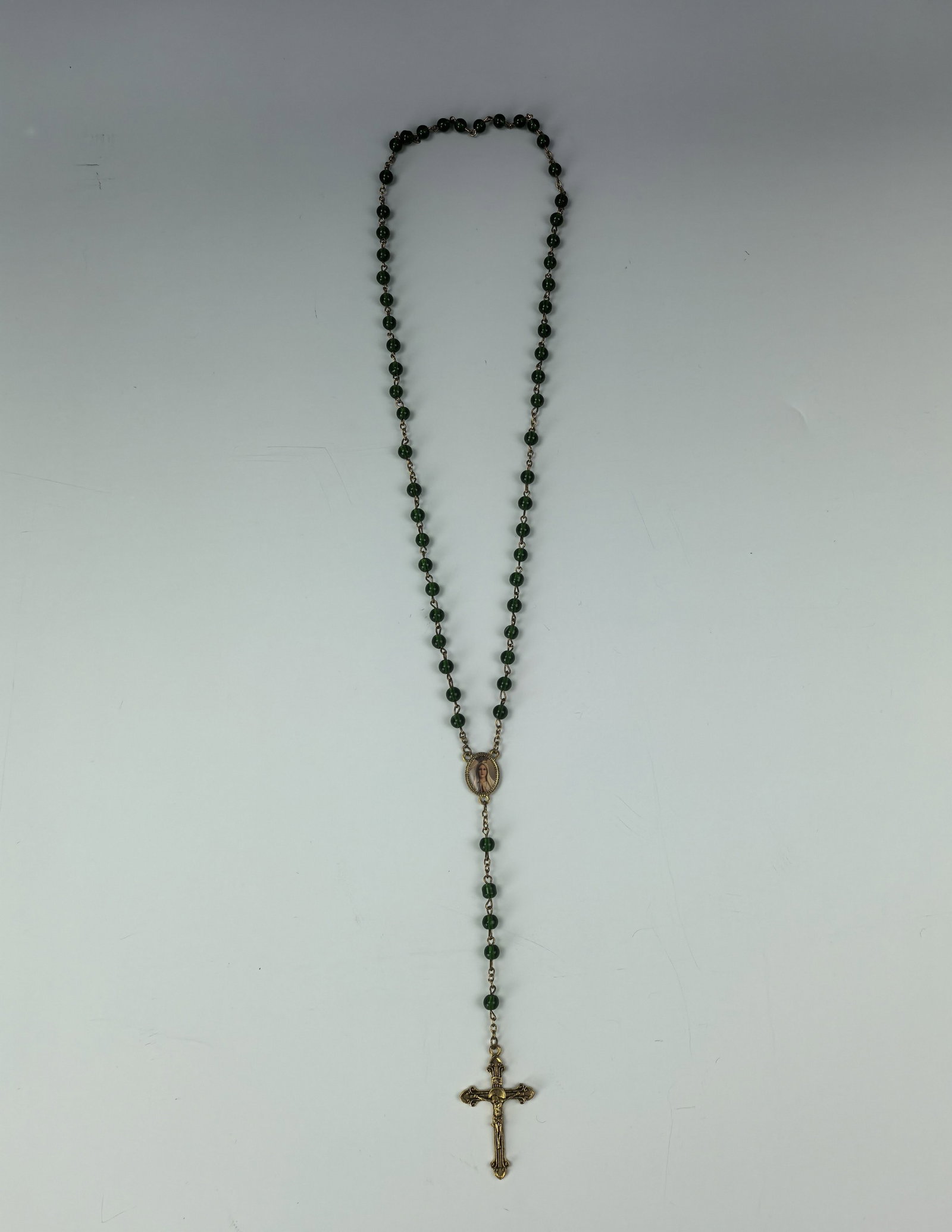 Religious Catholic green Glass Rosary Beads Necklace: Religious Catholic green Glass Rosary Beads Necklace, measures 20 inches , Preview from Oct. 14th to 18th from 1:00 PM TO 5:00 PM Eastern Time, Location: 15229 Display Court, Rockville MD 20850.