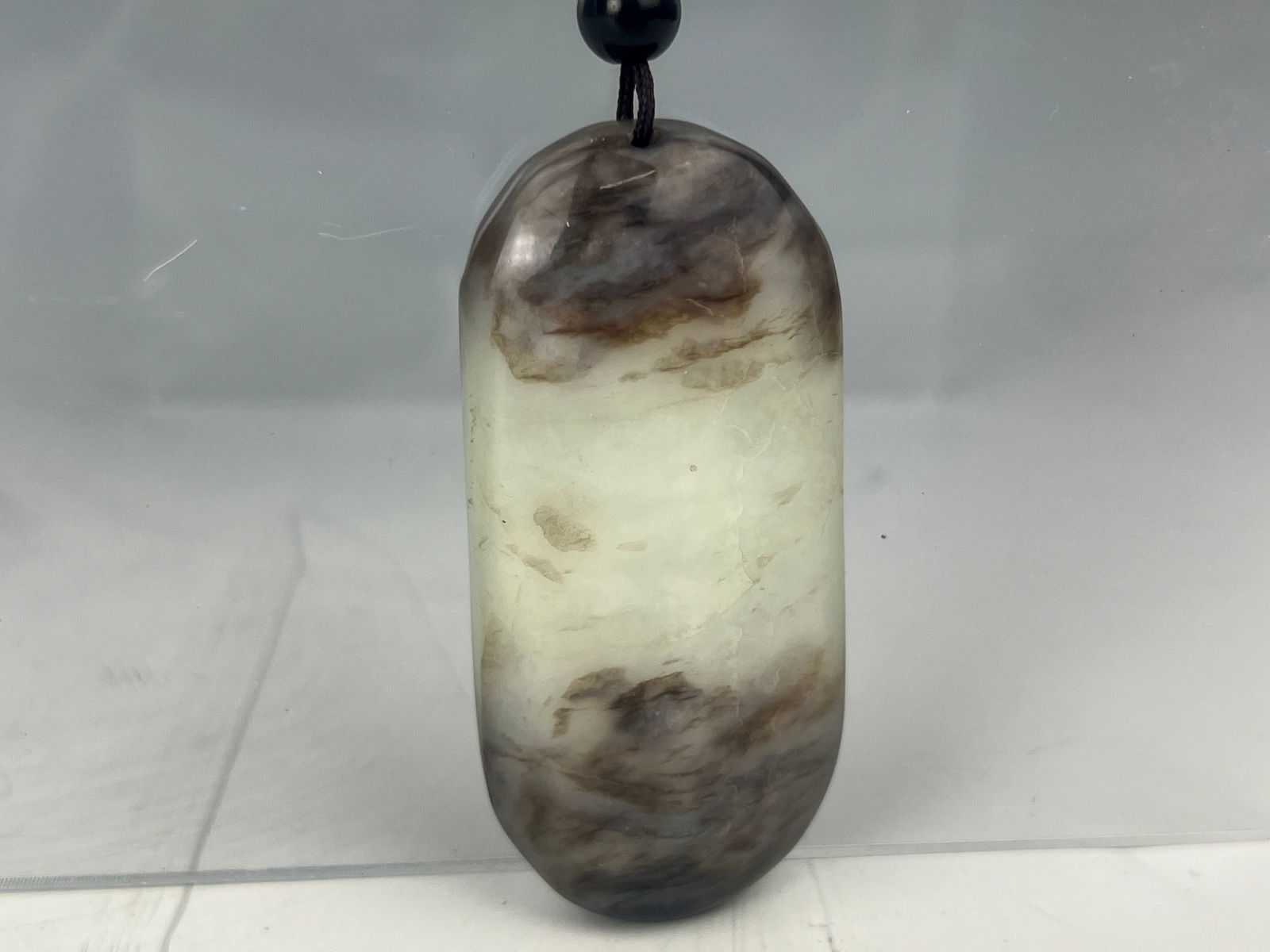 A Chinese Grey White Jade Carved Pendant: A Chinese Grey White Jade Carved Pendant, size 7 x 3 cm.Preview from Apr. 21st to 25th from 1:00 PM TO 5:00 PM Eastern Time, Location: 15229 Display Court, Rockville MD 20850.