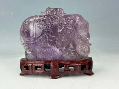 Amethyst Carved Elephant Statue onWood Stand: Amethyst carved statue of elephant and children on fitted wood stand,Size 14 x 10 x 5.5 cm. Preview from Aug. 25th to 29th from 1:00 PM TO 5:00 PM Eastern Time, Location: 15229 Display Court, Rockvill