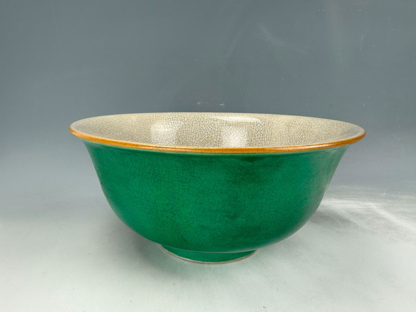 Large Chinese Green Glazed Porcelain Bowl with Fine Crackles: Large Green Glazed Porcelain Bowl with Fine Crackles.D 27 cm(10.5 in.) x H 15 cm(6 in.). Preview from Oct .21st to 24th from 1:00 PM TO 5:00 PM Eastern Time, Location: 15229 Display Court, Rockville M