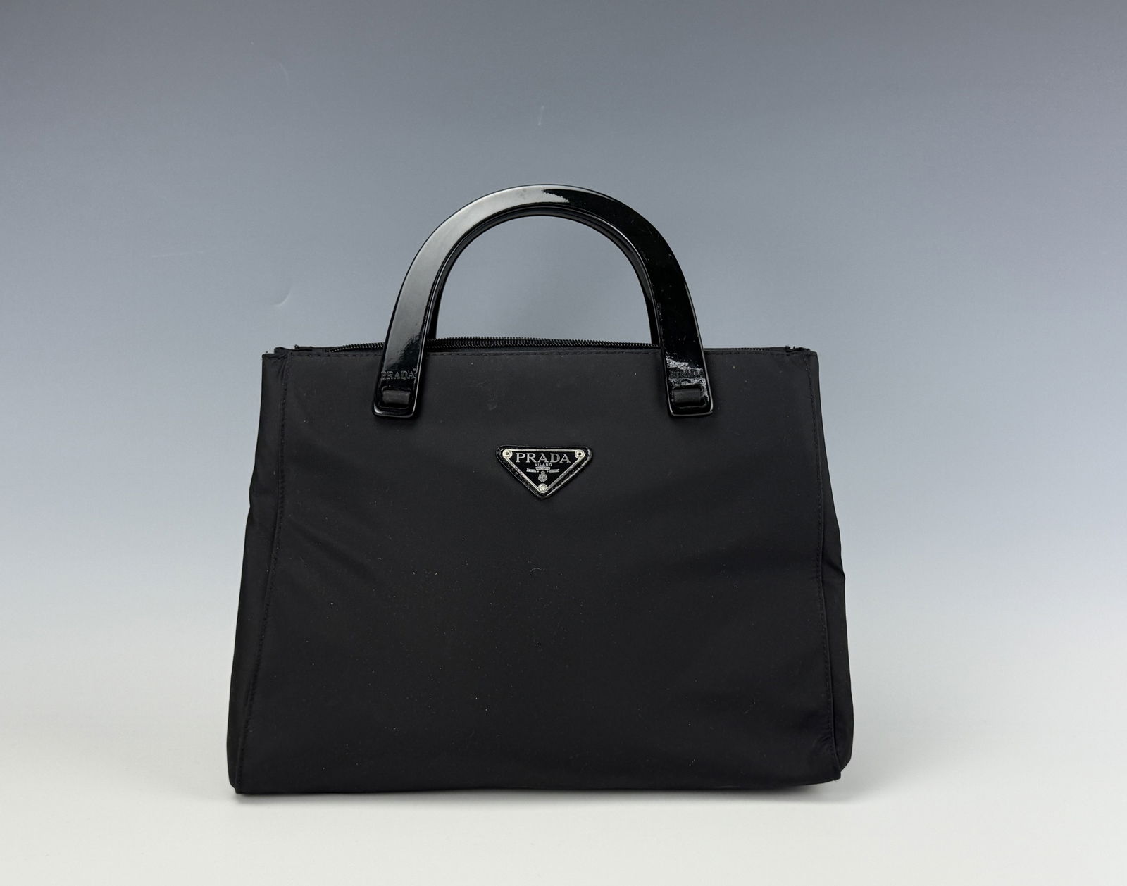 Vintage Prada Triangle Top Handle Bag: Vintage Prada Triangle Top Handle Bag,Size 12 x 9 x 5 inches ,Preview from Dec.15th to 19th from 1:00 PM TO 5:00 PM Eastern Time, Location: 15229 Display Court, Rockville, MD 20850.