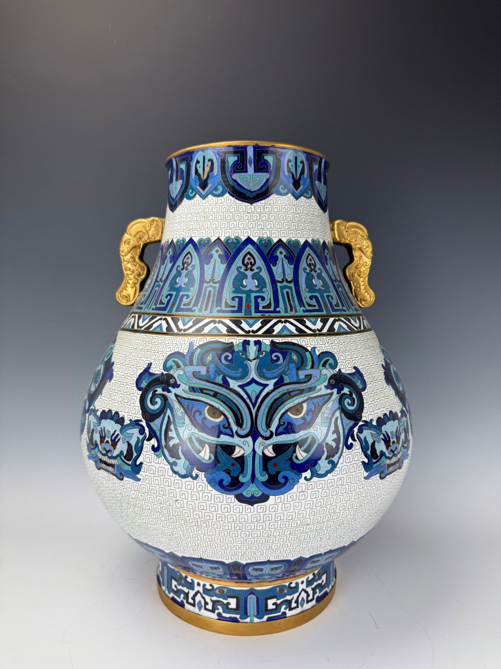 A Large Chinese Cloisonne Dragon Handle Vase with Mask Decoration: A Large Chinese Cloisonne Dragon Handle Vase with Mask Decoration,H 46 cm(18 in.) x W 33 cm(13 in.).Preview from Feb 23rd to 27th from 1:00 PM TO 5:00 PM Eastern Time, Location: 15229 Display Court, R