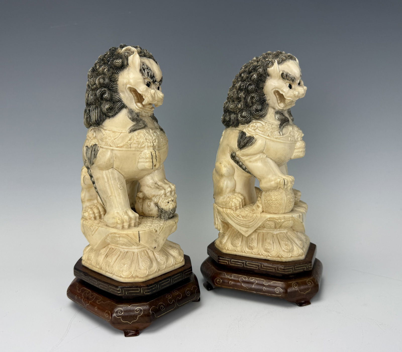 Pair of Antique Chinese Carved Bone Lions With Wood Base: Pair of Antique Chinese Carved Bone Lions on a wood pedestal,H 20.5cm (8.25in) x W 8.5cm (3.5in) x D 11cm (4.25cm) x2 .Preview from Feb 23rd to 27th from 1:00 PM TO 5:00 PM Eastern Time, Location: 152