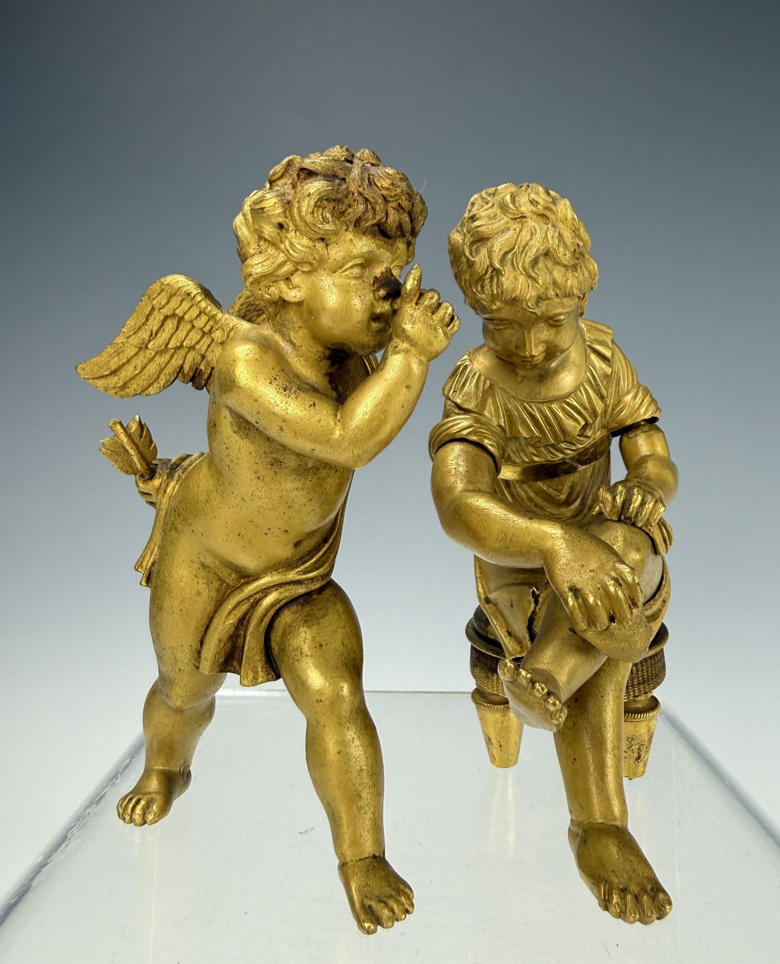 Two Antique Gilt Bronze Cherub and Figurine: Two Antique Gilt Bronze Cherub and Figurine.H 11 cm( 4.5 in.) x 2 .Preview from Feb 23rd to 27th from 1:00 PM TO 5:00 PM Eastern Time, Location: 15229 Display Court, Rockville, MD 20850.