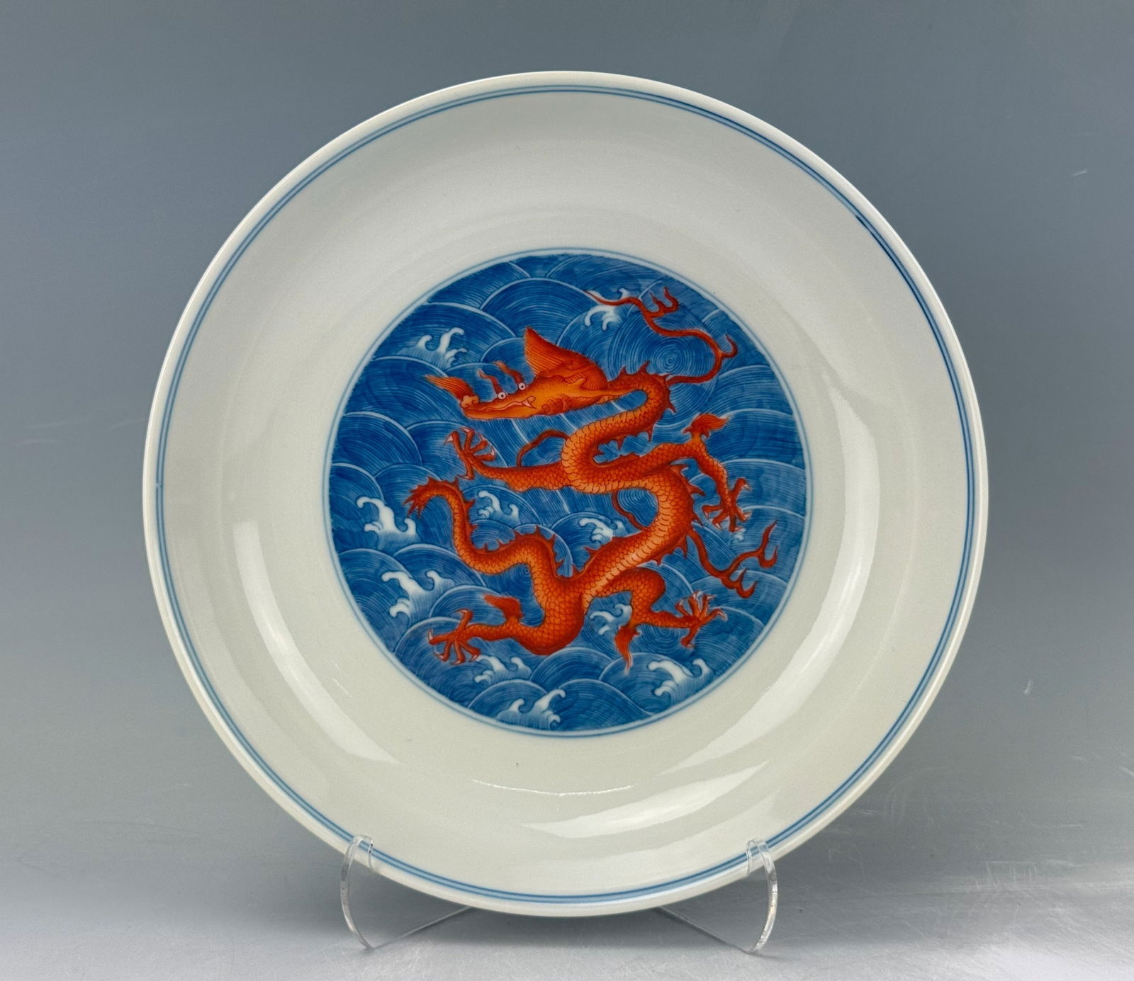 Chinese Blue and White Porcelain Plate with Red Dragons Qianlong Mark: Blue and White Imperial Style Plate Painted with Red Dragons Among Sea Waves,Qianlong Mark.D 18 cm(7 in.).Preview from Feb 23rd to 27th from 1:00 PM TO 5:00 PM Eastern Time, Location: 15229 Display Co