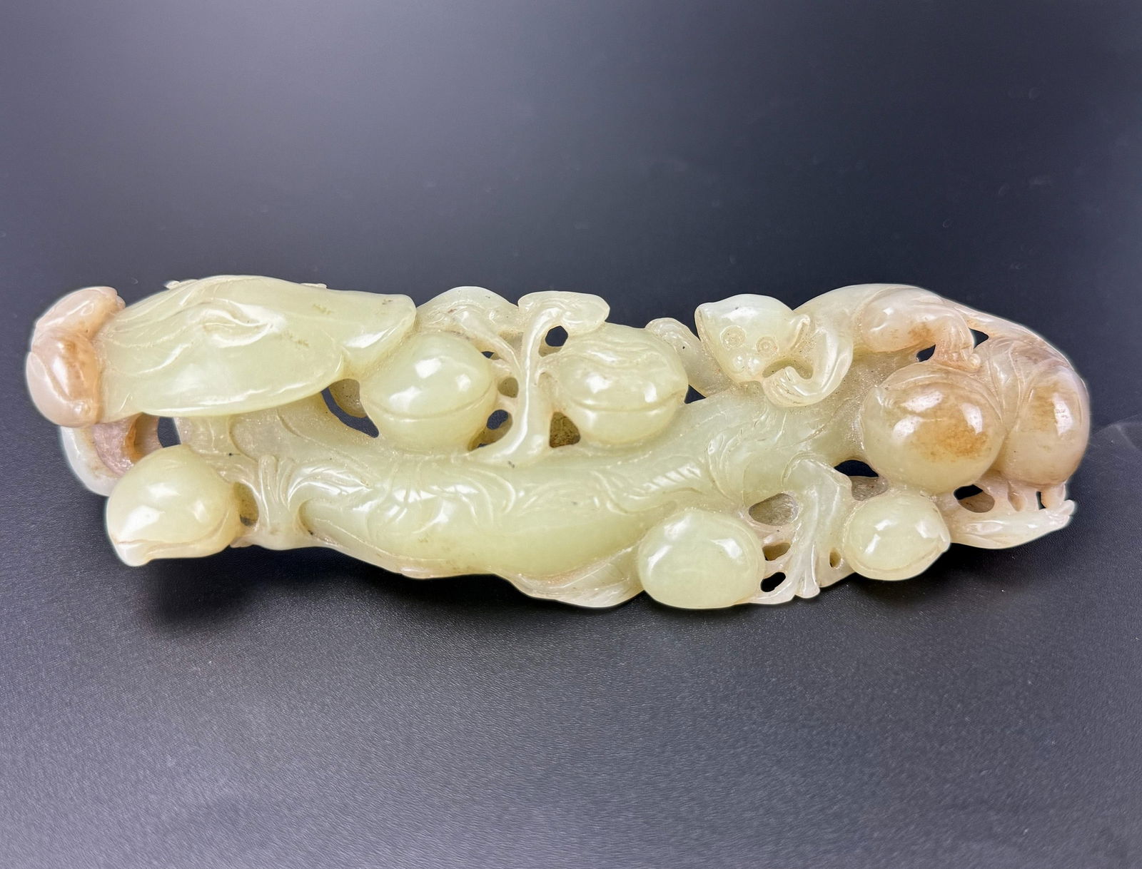 Chinese Carved Jade Ruyi with Peaches and Monkey: Chinese Carved Jade Ruyi Scepter, Adorned with Peaches, Monkeys, and Lingzhi Mushrooms,W 17 cm(6.5 in.) x D 5 cm(2 in.) x H 2.5 cm(1 in.).Preview from Apr 20th to 24th from 1:00 PM TO 5:00 PM Eastern