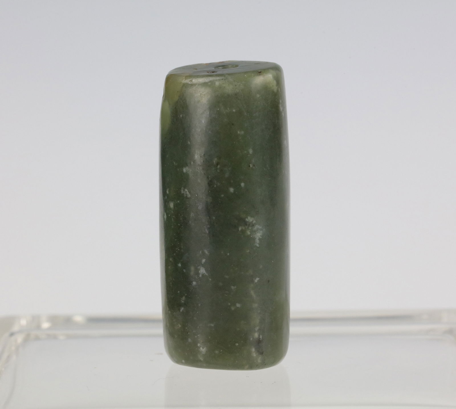 A Chinesde Celadon Jade Carved Bead: Celadon Jade carved bead, size 4.2 x 1.5 cm.Preview from Apr 20th to 24th from 1:00 PM TO 5:00 PM Eastern Time, Location: 15229 Display Court, Rockville, MD 20850.