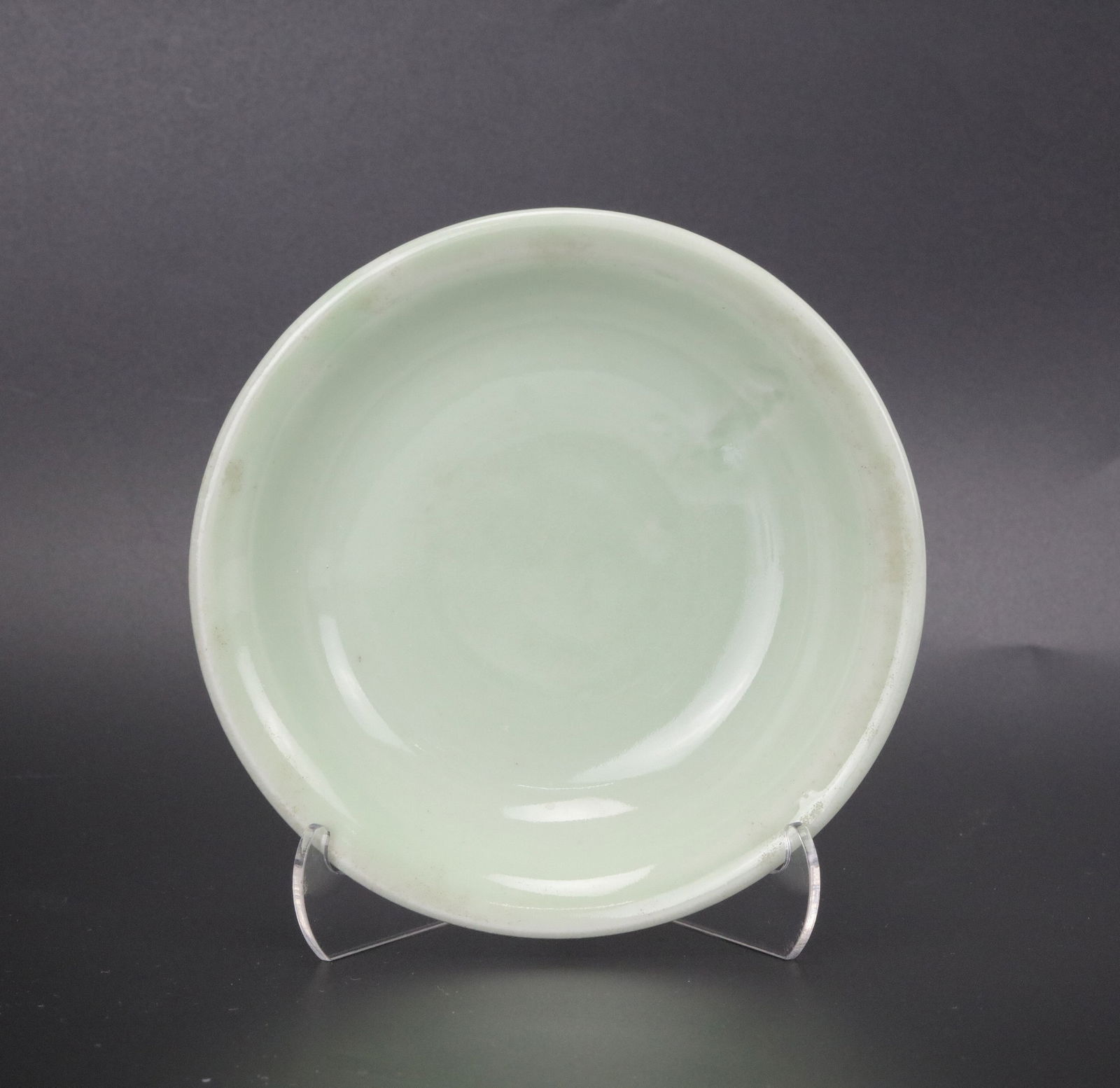 Chinese Celadon Glazed Shallow Bowl: Celadon glazed shallow bowl, D 13 cm(5.3in.) x H 4 cm(1.8 in.) x.Preview from Apr 20th to 24th from 1:00 PM TO 5:00 PM Eastern Time, Location: 15229 Display Court, Rockville, MD 20850.