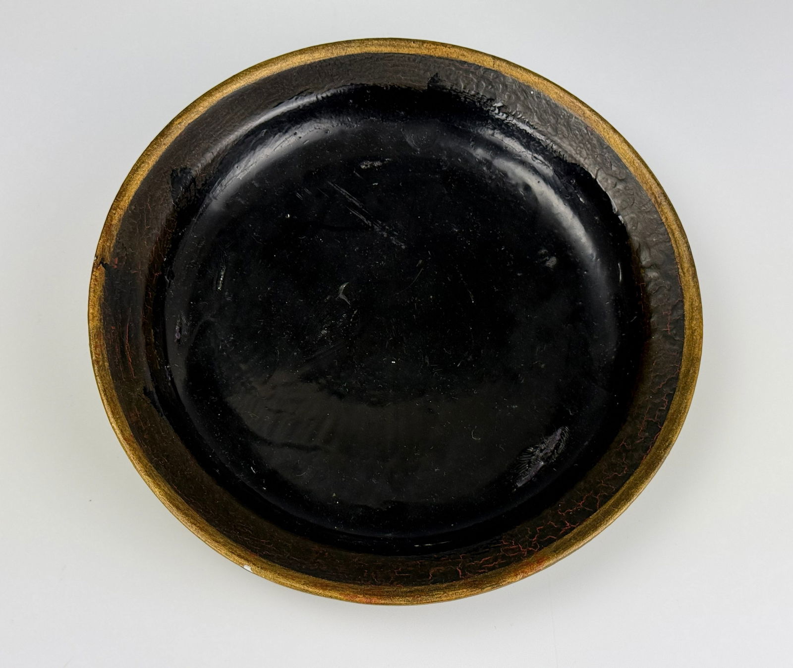 Chinese Antique Porcelain Plate Imitating Black Lacquer: Chinese Antique Porcelain Plate Imitating Black Lacquer,D 25.4 cm(10in.) x H 4.4 cm( 1.9in.).Preview from Apr 20th to 24th from 1:00 PM TO 5:00 PM Eastern Time, Location: 15229 Display Court, Rockvill