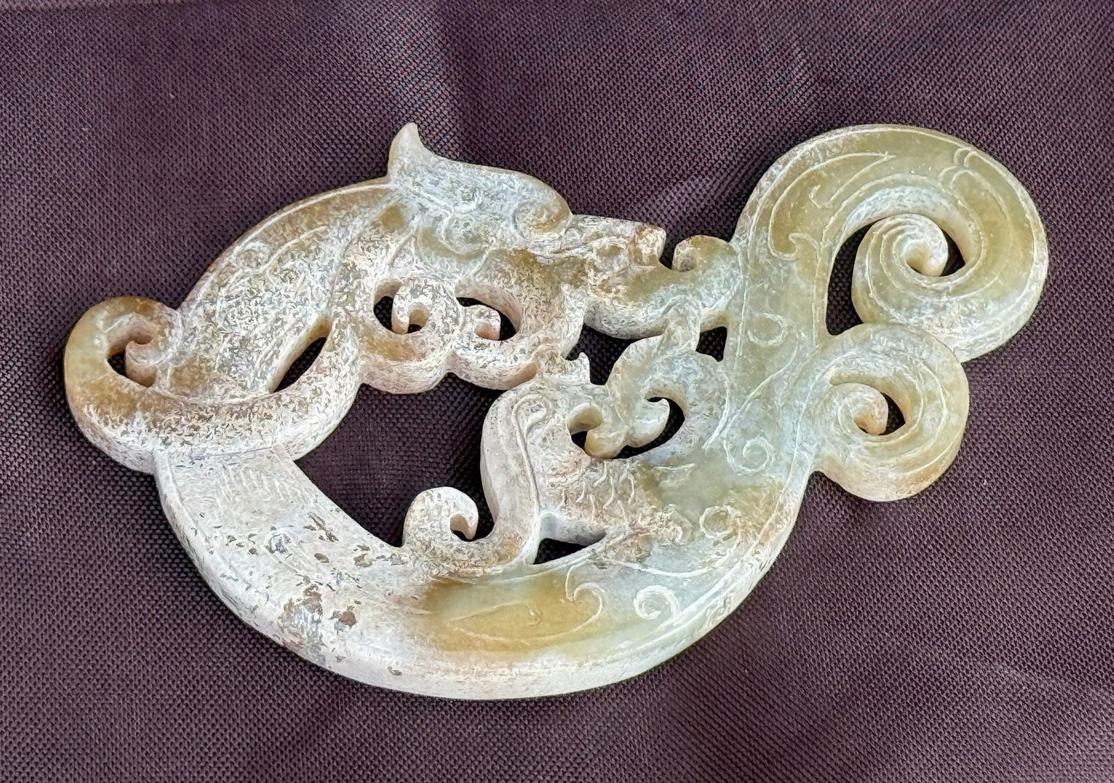Celadon Jade Carved Pendant of Dragon Pattern: Celadon Jade carved archer rich with cloud pattern, size 8 x 4.6 cm.Preview from Apr 20th to 24th from 1:00 PM TO 5:00 PM Eastern Time, Location: 15229 Display Court, Rockville, MD 20850.