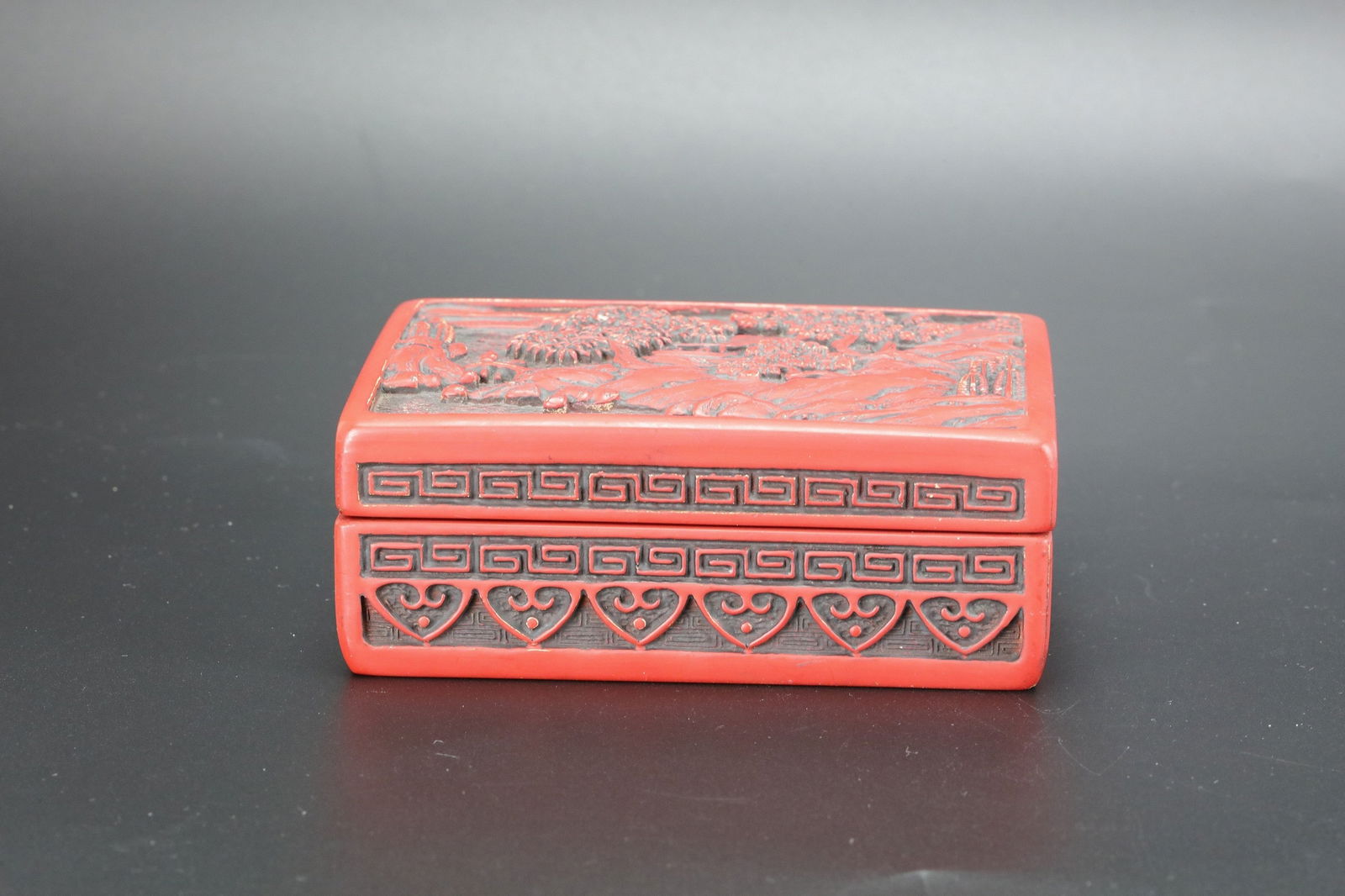 A Chinese Carved red Cinnabar Lacquer Box: A Chinese Carved red Cinnabar Lacquer Box,size 11.6 x 8.3 x 4.2 cm.Preview from Apr 20th to 24th from 1:00 PM TO 5:00 PM Eastern Time, Location: 15229 Display Court, Rockville, MD 20850.