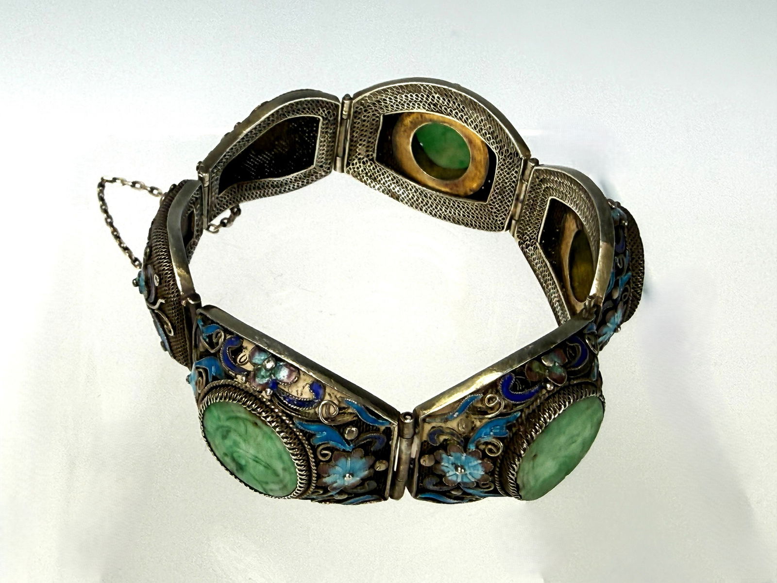 Chinese Gilt Filigree Sterling Silver Enameled Jadeite Bracelet: An antique Chinese filigree bracelet featuring carved green jadeite and intricate cloisonné enamel work, early 20th century,Preview from Apr 20th to 24th from 1:00 PM TO 5:00 PM Eastern Time, Locatio