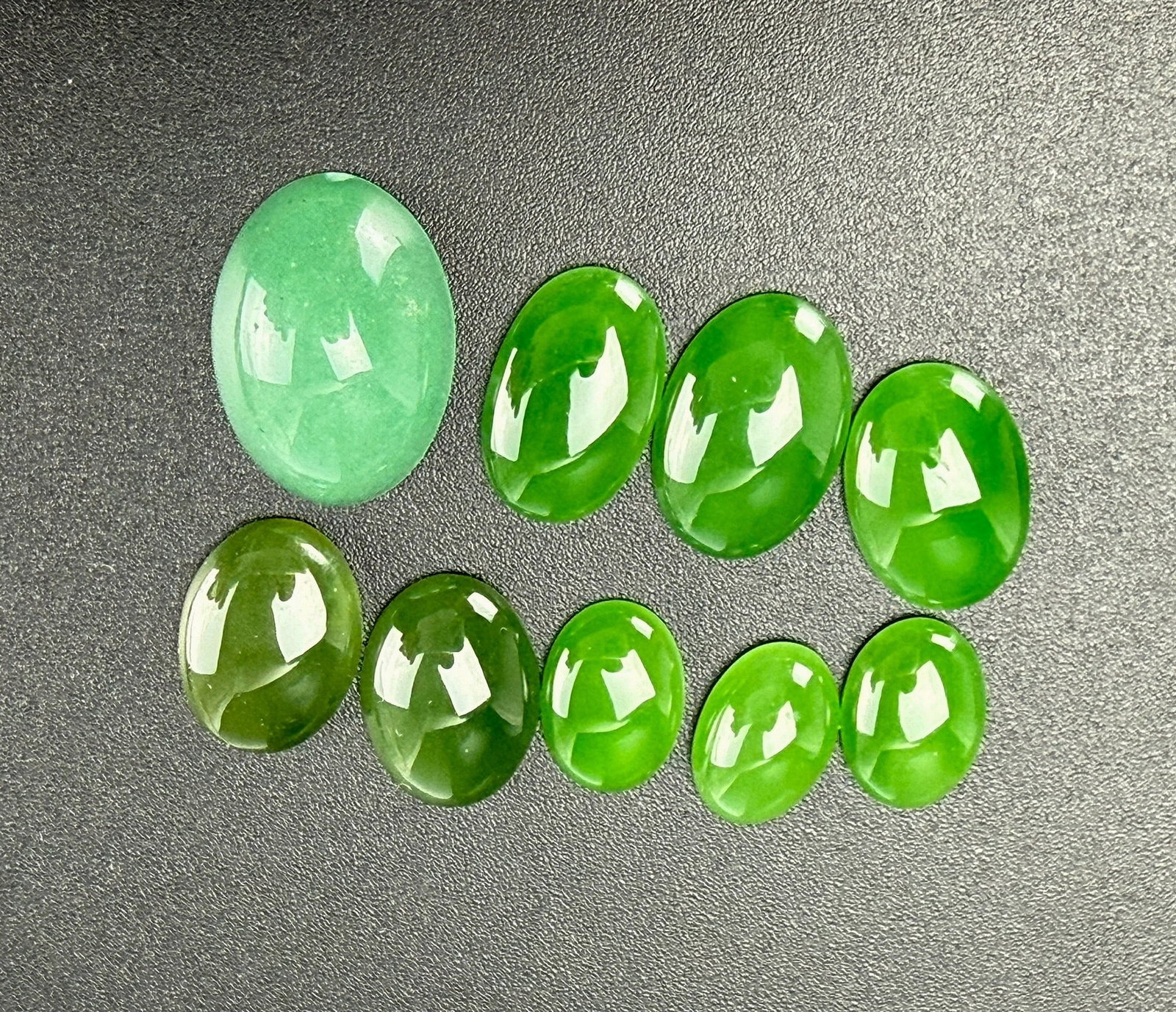 Groupm of 9 Green Jadeite and Nephrite Oval Cabochons: Blue & White wide- mouthed jar with a lacquer lid. In old customized box , H 21.5 cm(8 in.) x W 12.4 cm(4.9 in.).Preview from Apr 20th to 24th from 1:00 PM TO 5:00 PM Eastern Time, Location: 15229 Dis