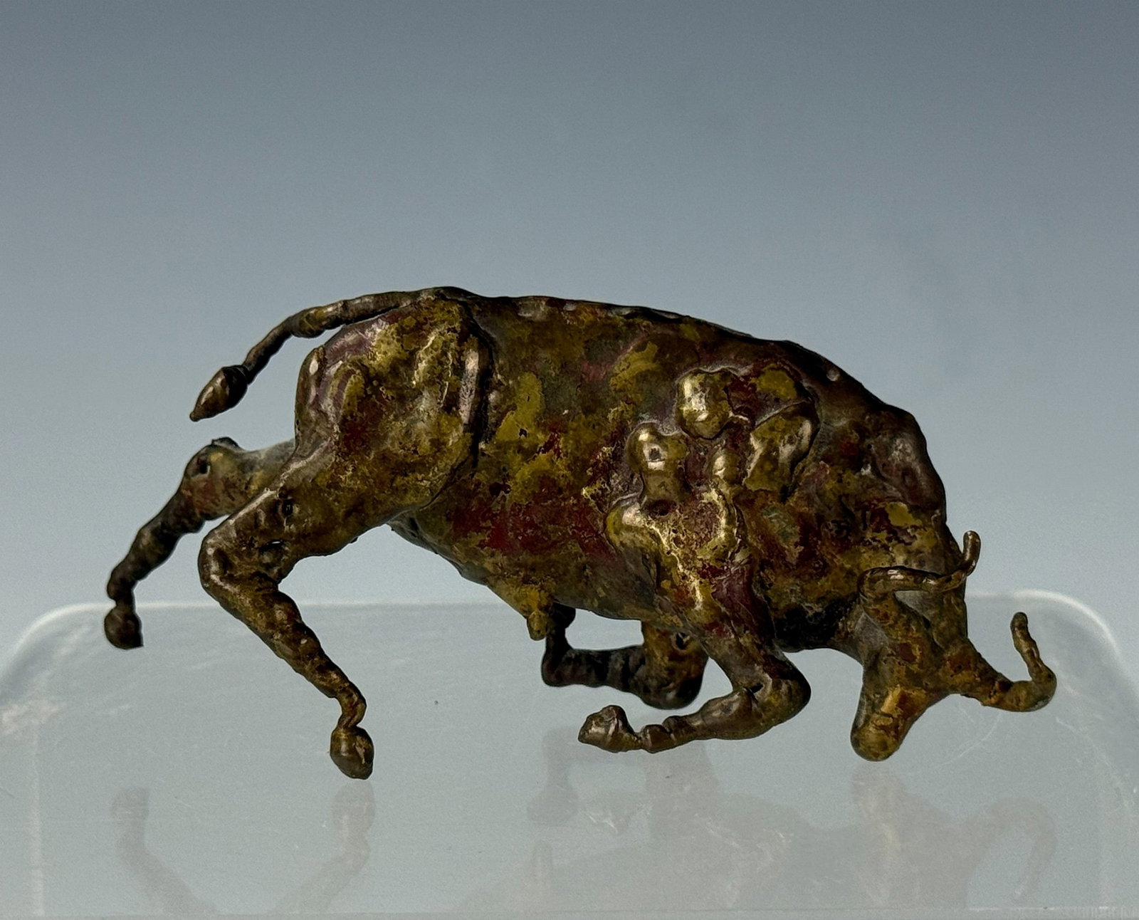 A Vintage Bronze Bull Statue: A Vintage Bronze Bull Statue, W 10 cm(3.9in) x H4 cm(1.6in.).Preview from Apr 20th to 24th from 1:00 PM TO 5:00 PM Eastern Time, Location: 15229 Display Court, Rockville, MD 20850.