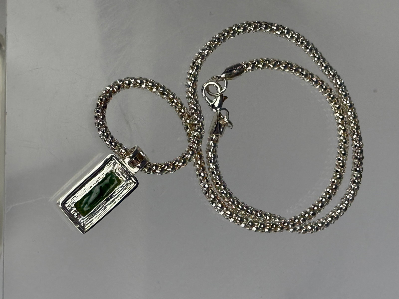 A Silver Colored Necklace with Green Rectangular Jade Pendant (1 of 1)