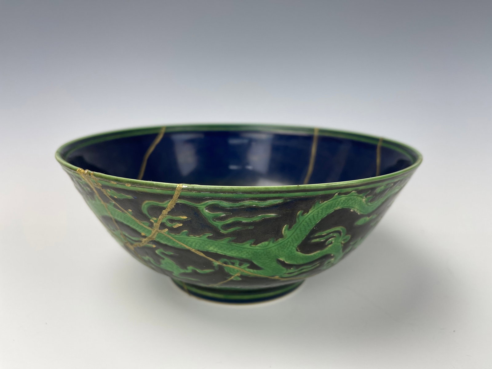 A Rare Blue Ground Green Dragon Porcelain Bowl Chenghua Mark: A Rare Blue Ground Green Dragon Porcelain Bowl Chenghua Mark. D 18.6cm (7.5in) x H 8cm (3in).it's repaired, sold as is. Preview from Apr 20th to 24th from 1:00 PM TO 5:00 PM Eastern Time, Location: 15