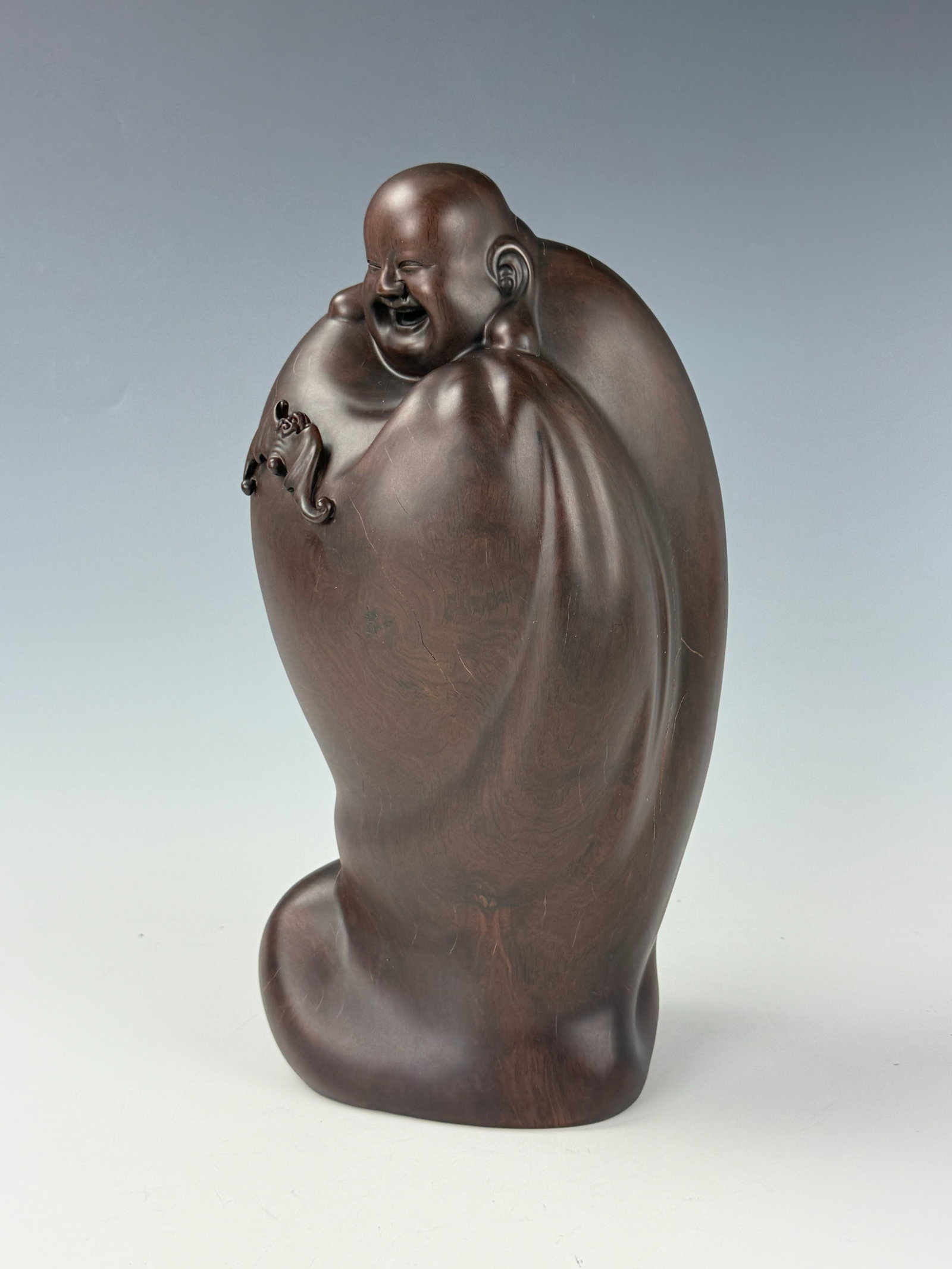 Chinese Wooden Carving of laughing Buddha with Small Bat: Wooden Carving of laughing Buddha with small bat , H30cm (in) x W5cm (5.3in). Preview from Apr 20th to 24th from 1:00 PM TO 5:00 PM Eastern Time, Location: 15229 Display Court, Rockville, MD 20850.