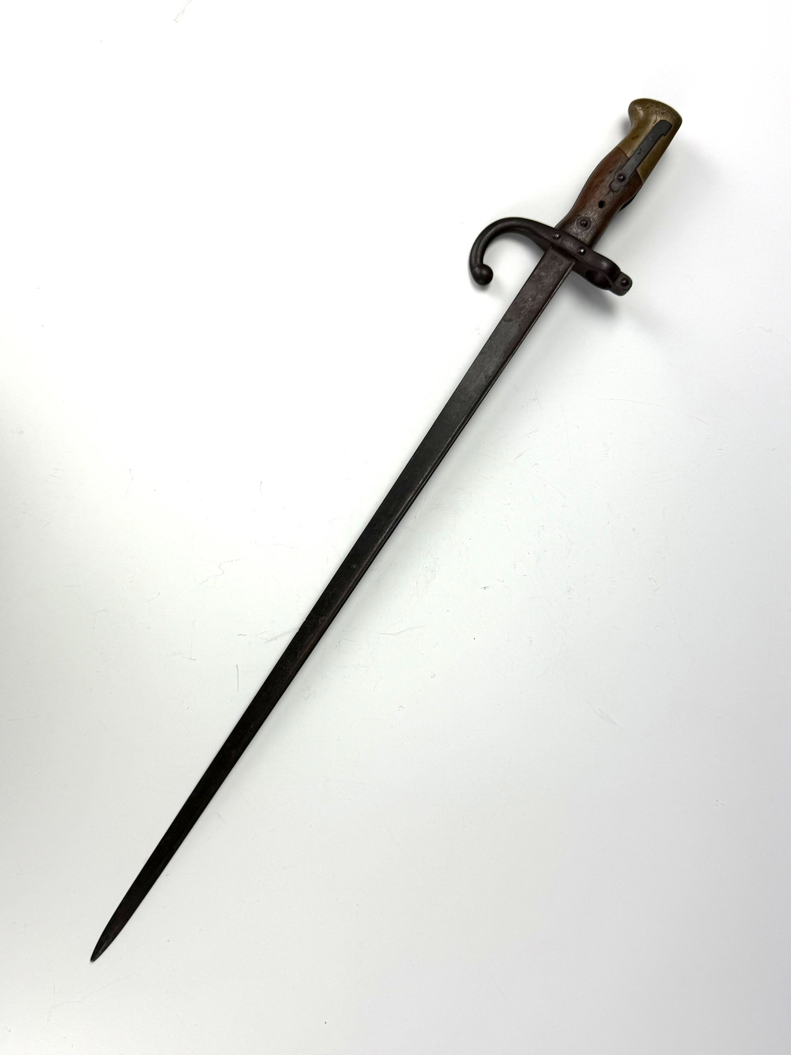 WWII narrow steel bayonet with a wooden grip: a long narrow steel bayonet with a wooden grip. L 64cm (25in). Preview from Apr 20th to 24th from 1:00 PM TO 5:00 PM Eastern Time, Location: 15229 Display Court, Rockville, MD 20850.