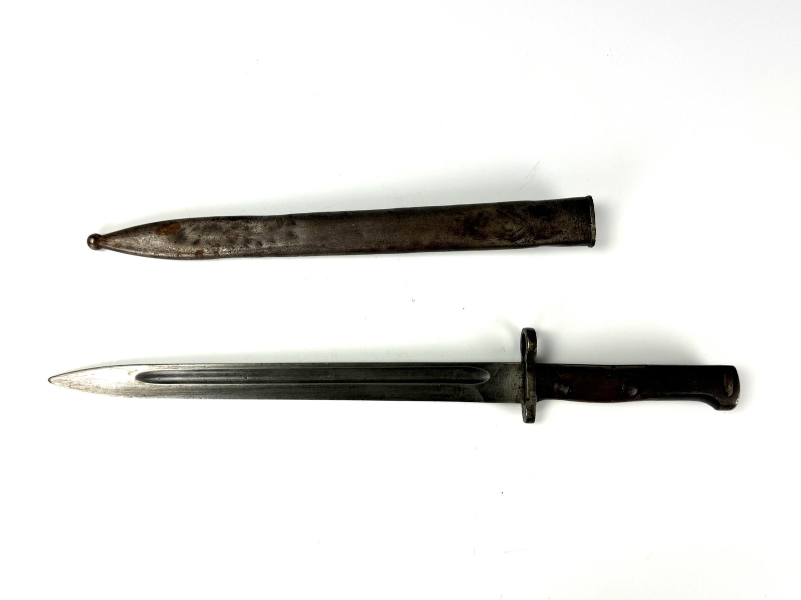 A WWII steel bayonet for mounting on a military rifle: A steel bayonet with a fullered blade and metal scabbard, designed for mounting on a military rifle. L45cm (17.7in) Preview from Apr 20th to 24th from 1:00 PM TO 5:00 PM Eastern Time, Location: 15229