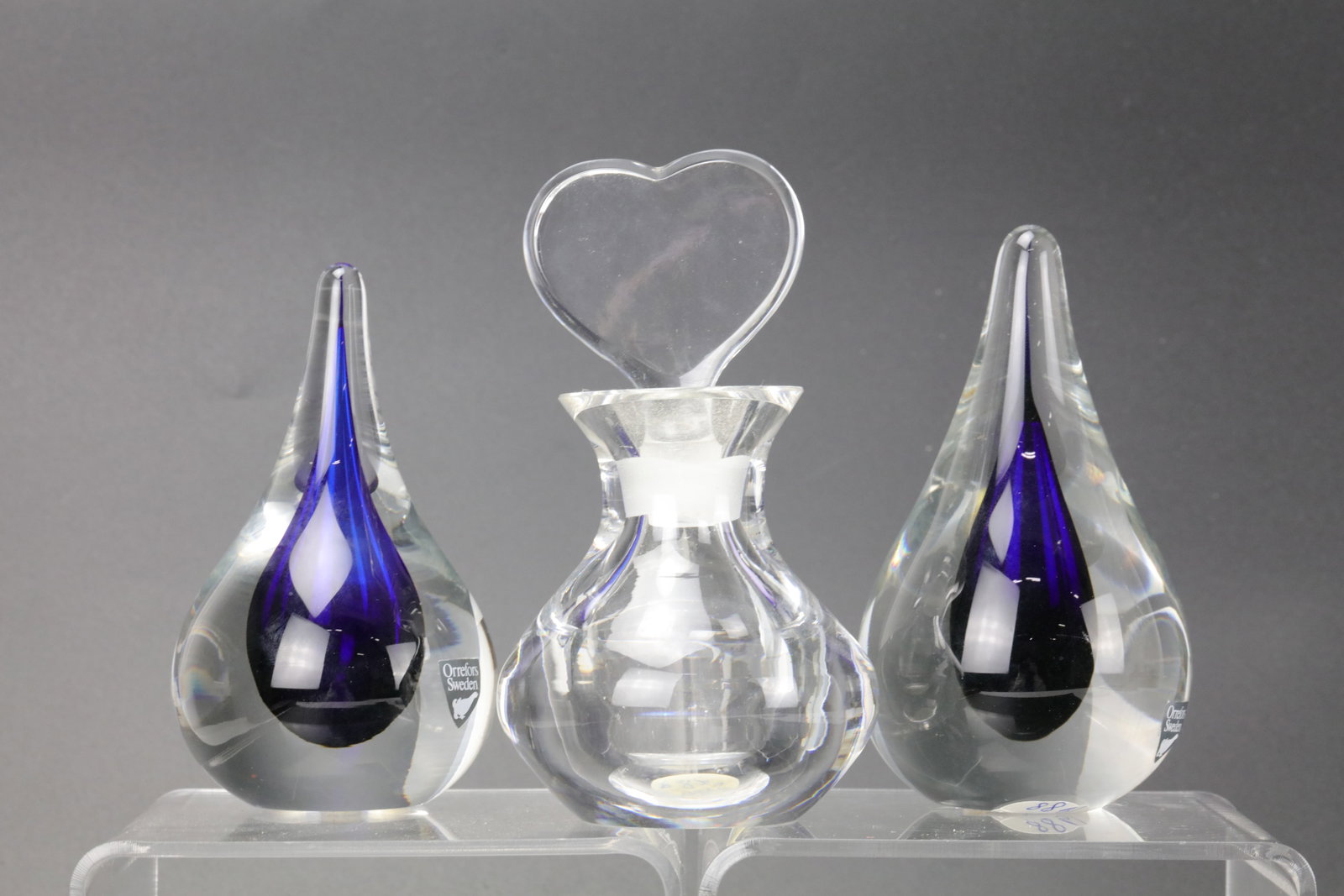 Vintage Orrefors Sweden Crystal 3 Pieces, Two Teardrop Paperweights with a Blue Drop Encased in: Vintage Orrefors Sweden Crystal 3 Pieces, Two Teardrop Paperweights with a Blue Drop Encased in Clear Crystal, One Perfume Bottle, H10cm(4in). Preview from Apr 20th to 24th from 1:00 PM TO 5:00 PM Eas