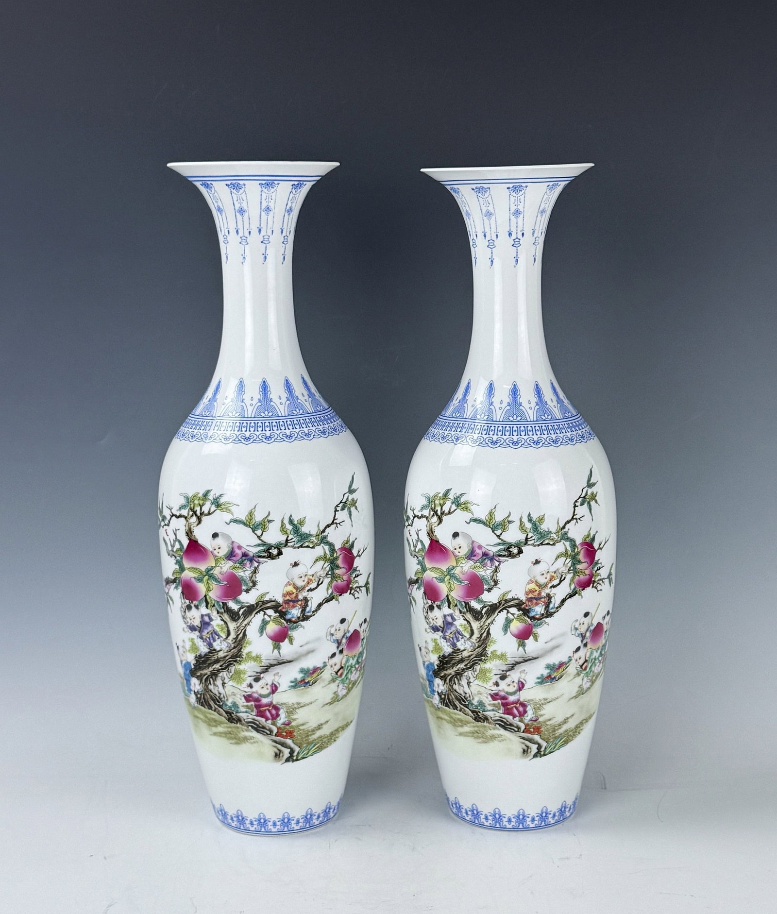 Pair of Chinese Famille Rose Eggshell Porcelain Vases Jingdezhen Mark: Pair of tall porcelain vases with blue rims and children?and?peach tree scenes. H 41.5 cm(16.3 in.) x 2,Preview from June 22nd to 26th from 1:00 PM TO 5:00 PM Eastern Time, Location: 15229 Display Cou