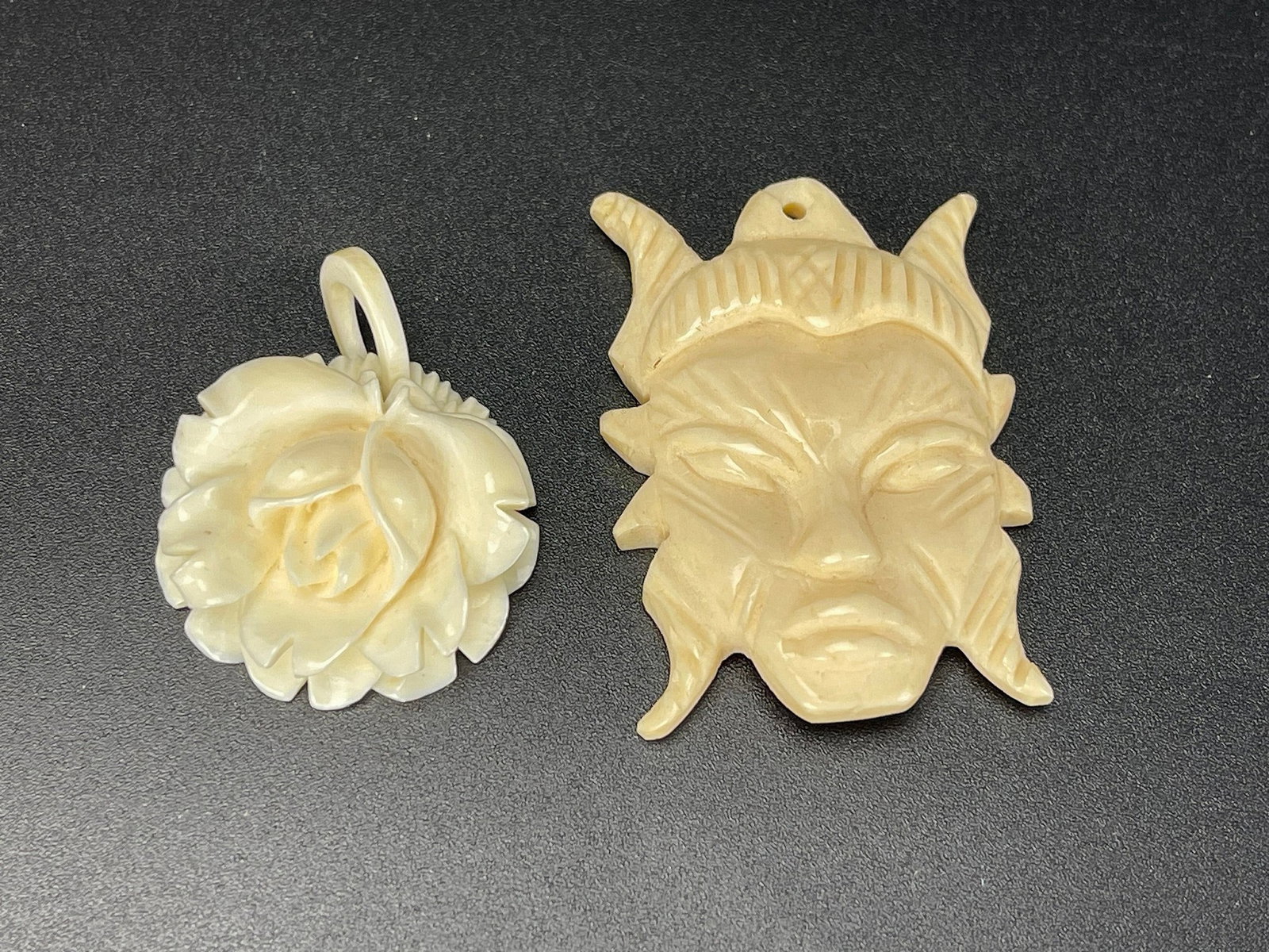Two Carved Cattle Bone Pendants Floral Rose and Tribal Style Face (1 of 2)