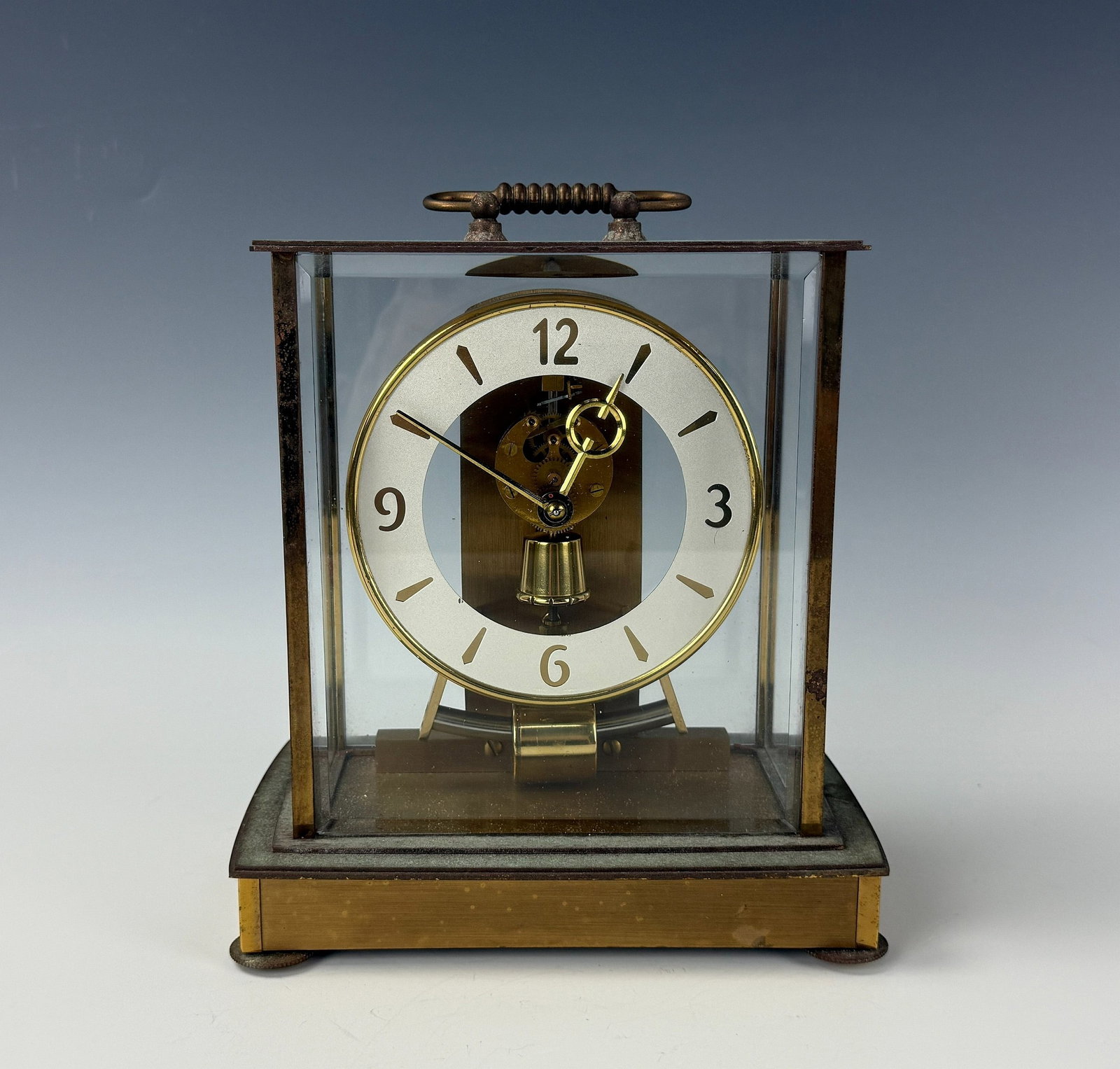 Vintage Western Germany Kieninger and Obergfell Clock: Kieninger & Obergfell Glass & Brass Mechanical Clock, 6 Jewel West Germany. H 21cm(8.2in.) x W 20cm(7.9 in.) x D 13cm(5.1 in.). Preview from June 22nd to 26th from 1:00 PM TO 5:00 PM Eastern Time, Loc