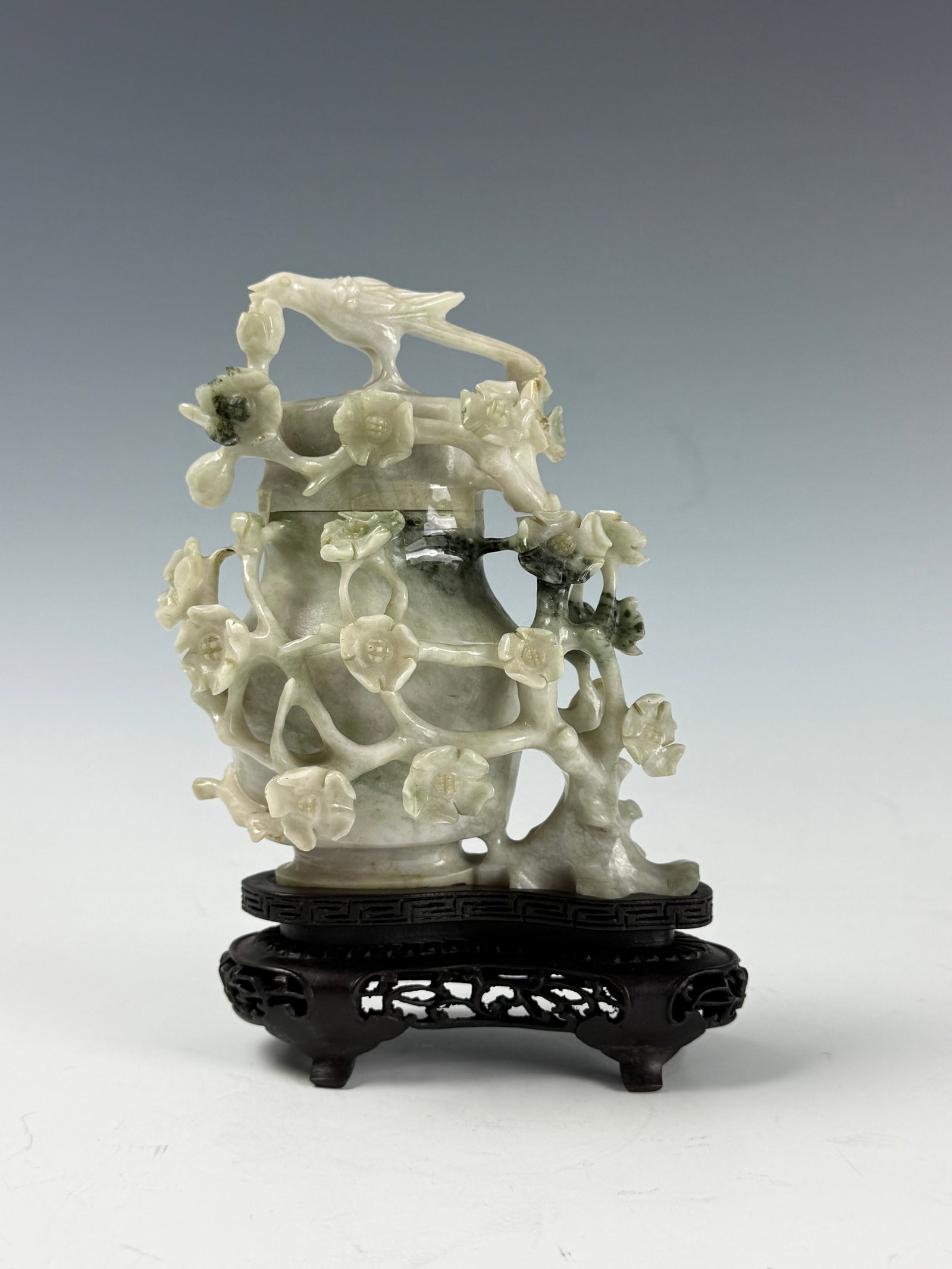 Chinese Carved Jade Vase with Floral and Bird on Wood Stand: Chinese Carved Jade Vase with Floral and Bird on Wood Stand,H 13 cm(5.3 in.) x W 10 cm(4 in.).Preview from June 22nd to 26th from 1:00 PM TO 5:00 PM Eastern Time, Location: 15229 Display Court, Rockvi