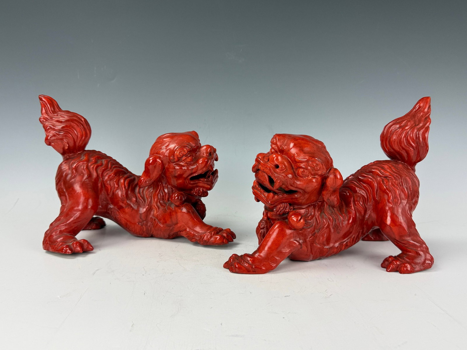 Pair of Chinese Red Glazed Porcelain Figures of Foo Lions: Pair of Chinese Red Glazed Porcelain Figures of Foo Lions. W 24 cm(9.5in.) x H 18 cm(7.1in.) x D 16 cm(6.4in.). Preview from June 22nd to 26th from 1:00 PM TO 5:00 PM Eastern Time, Location: 15229 Dis