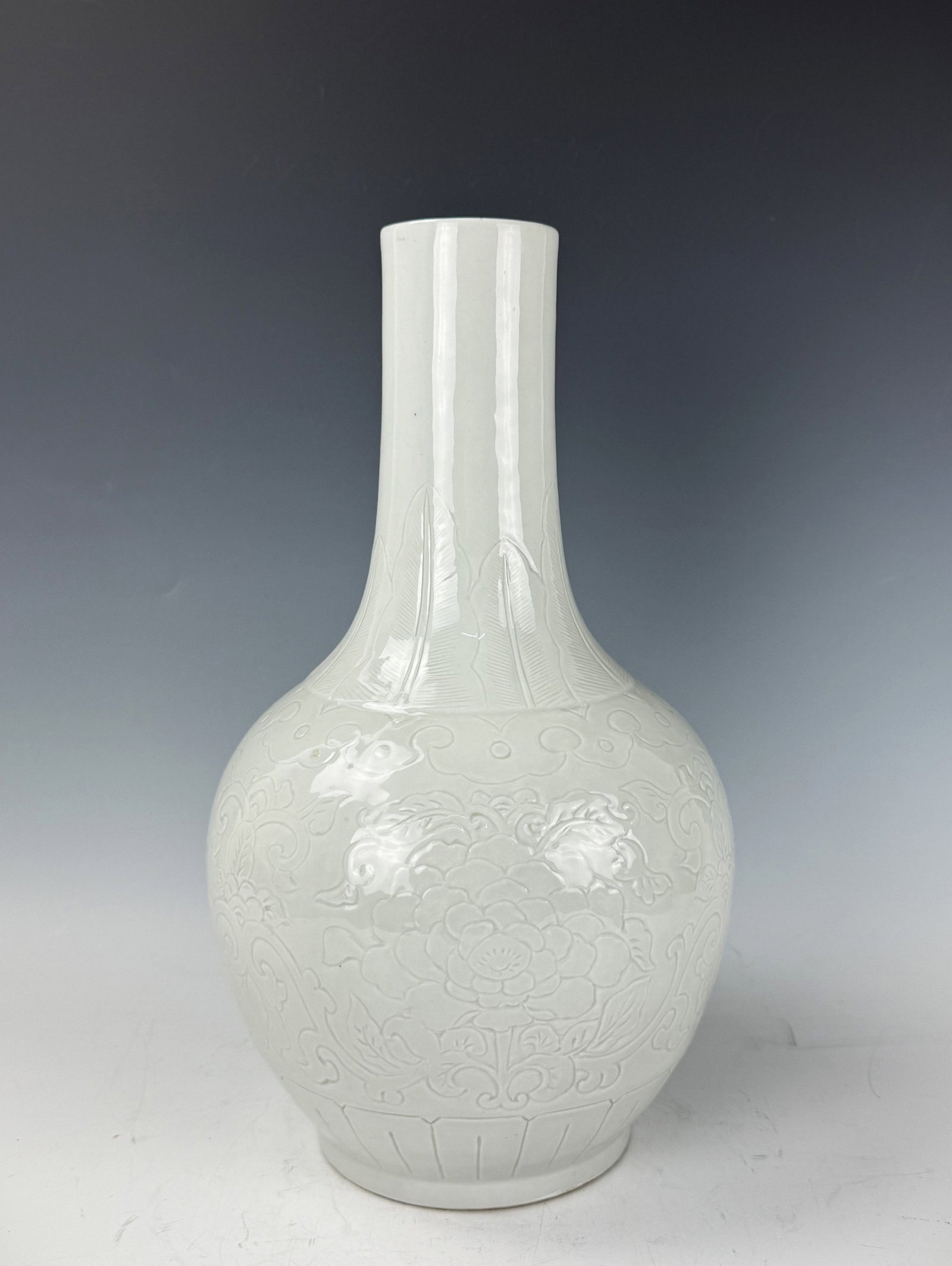 Antique Chinese White Porcelain Vase Incised Peony Patterns: White Porcelain Vase with Relief Floral Decoration. H 40 cm (15.7in.). Preview from June 22nd to 26th from 1:00 PM TO 5:00 PM Eastern Time, Location: 15229 Display Court, Rockville, MD 20850.