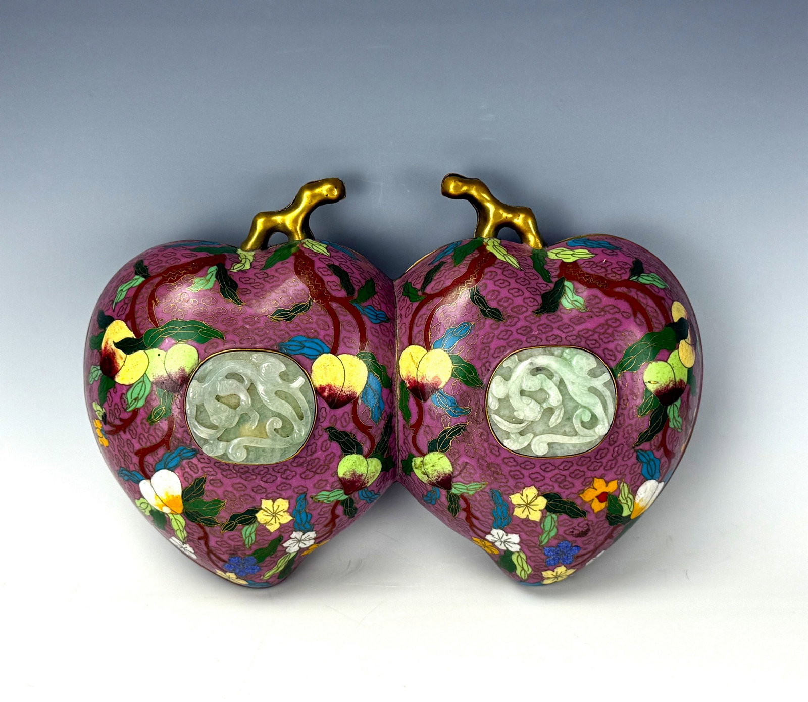 Chinese Cloisonne Double Peach Box with Jade Inset lids: Chinese cloisonne double peach box with jade inset lids and floral enamel decoration. L 30.5cm(12 in.) x W 20cm(8in.) x H 11cm(4.3 in.). Preview from June 22nd to 26th from 1:00 PM TO 5:00 PM Eastern 