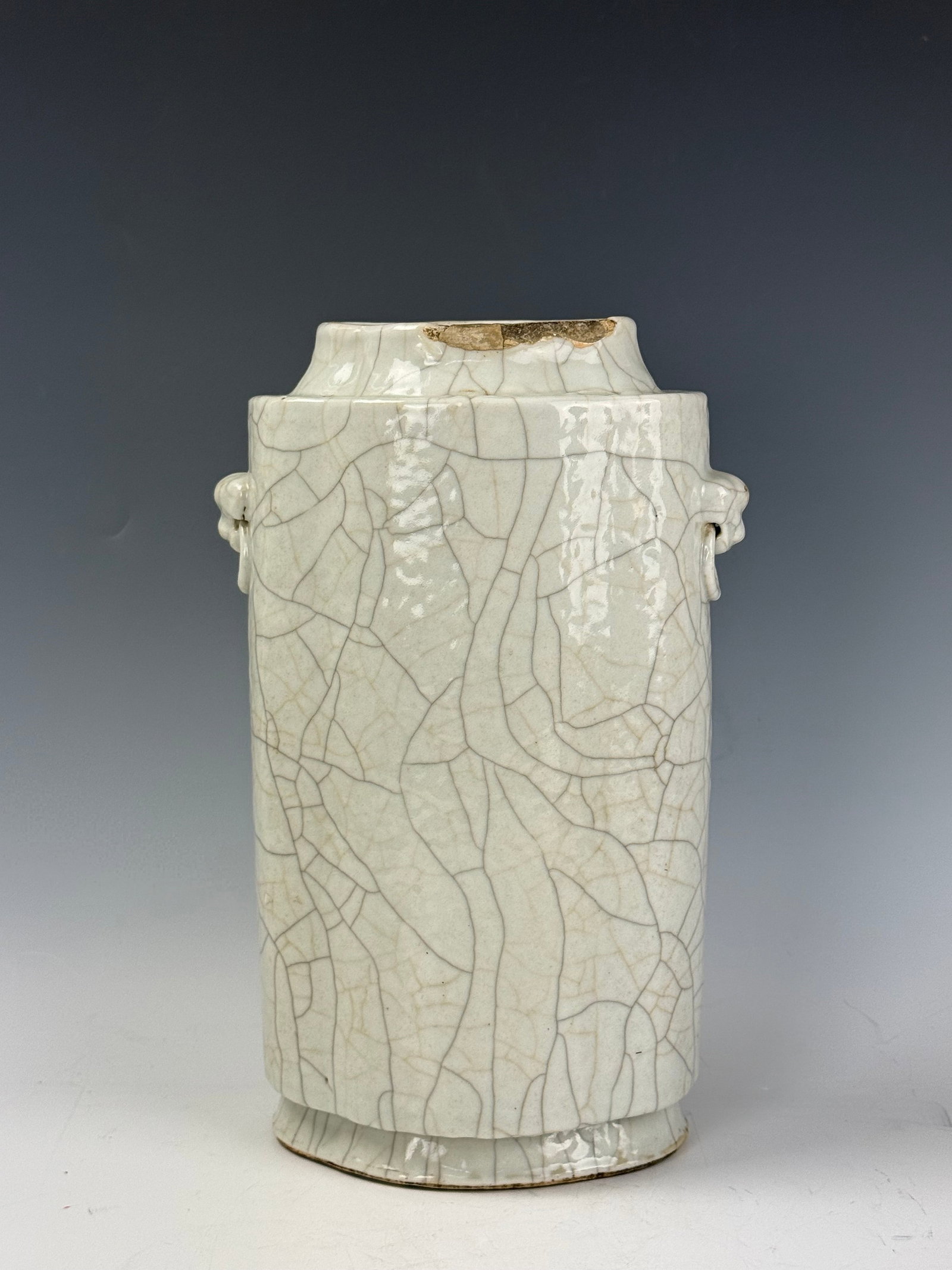 Chinese Guan Stype Porcelain Vase With Double Handles: Guan stype vase in the shape of a floral CONG with double elephant heads. Drilled and sold as is. H 31.5cm(12.4 in.) x D16.3cm(6.4 in.). Preview from June 22nd to 26th from 1:00 PM TO 5:00 PM Eastern 