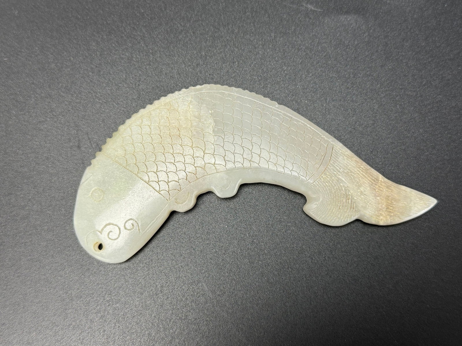 Chinese Carved Jade Fish Form Pendant: Chinese Carved Jade Fish Form Pendant, L 10cm(3.9in.) x W 3.4cm(1.3in.). Preview from June 22nd to 26th from 1:00 PM TO 5:00 PM Eastern Time, Location: 15229 Display Court, Rockville, MD 20850.