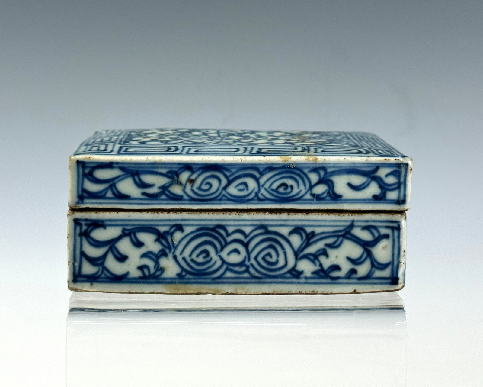 Chinese Blue and White Porcelain Covered Box with Floral Scrolls: Chinese Blue and White Porcelain Covered Box with Floral Scrolls. Size 11x 8 x 4.5 cm. Preview from June 22nd to 26th from 1:00 PM TO 5:00 PM Eastern Time, Location: 15229 Display Court, Rockville, MD