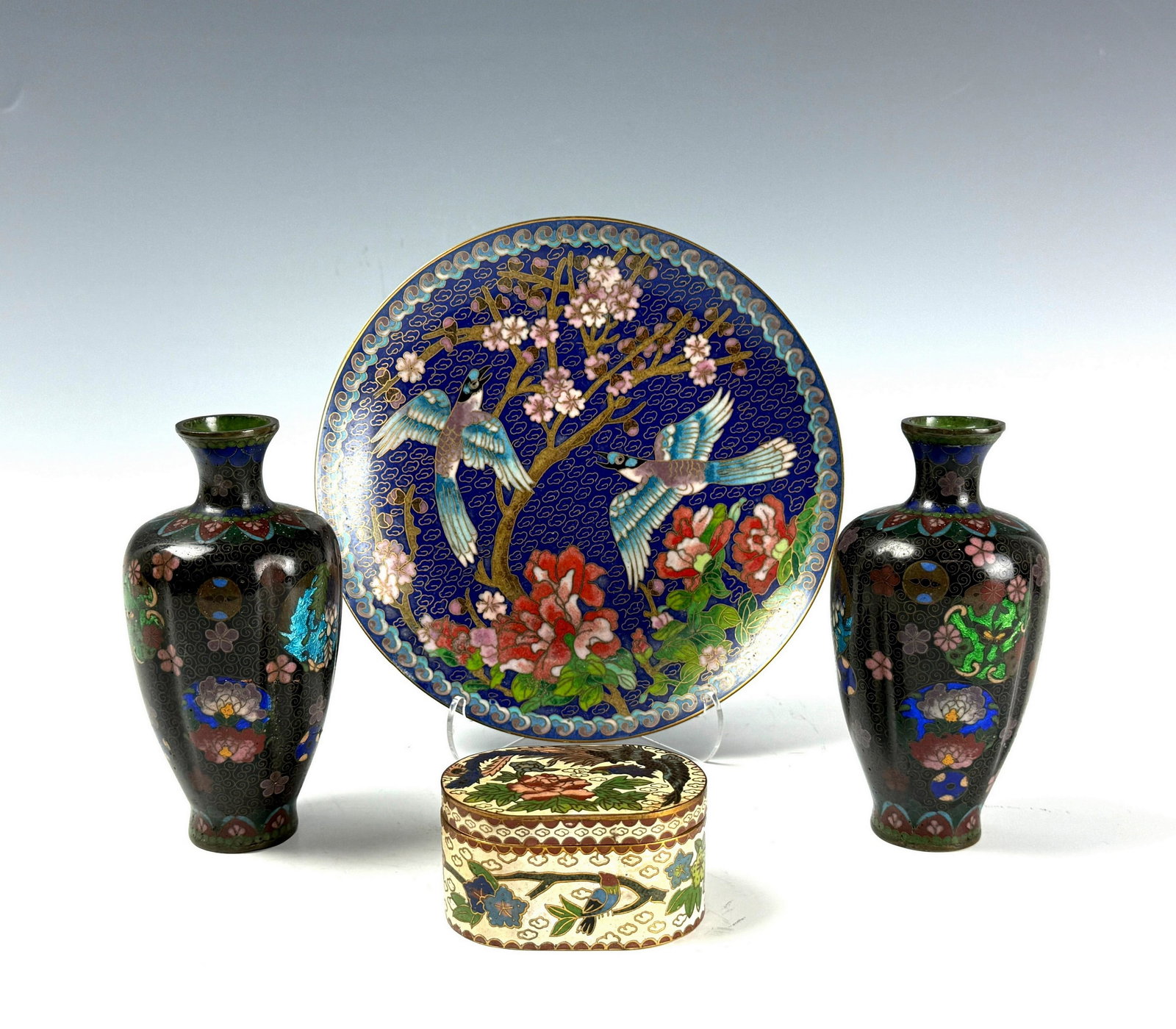 Group of 4 Cloisonne Enamel Vases and Plate and Oval Box: Group of 4 Cloisonne Enamel Vases H 13 cm, Plate D 18 cm and Oval Box W 7.3 cm. Preview from June 22nd to 26th from 1:00 PM TO 5:00 PM Eastern Time, Location: 15229 Display Court, Rockville, MD 20850.