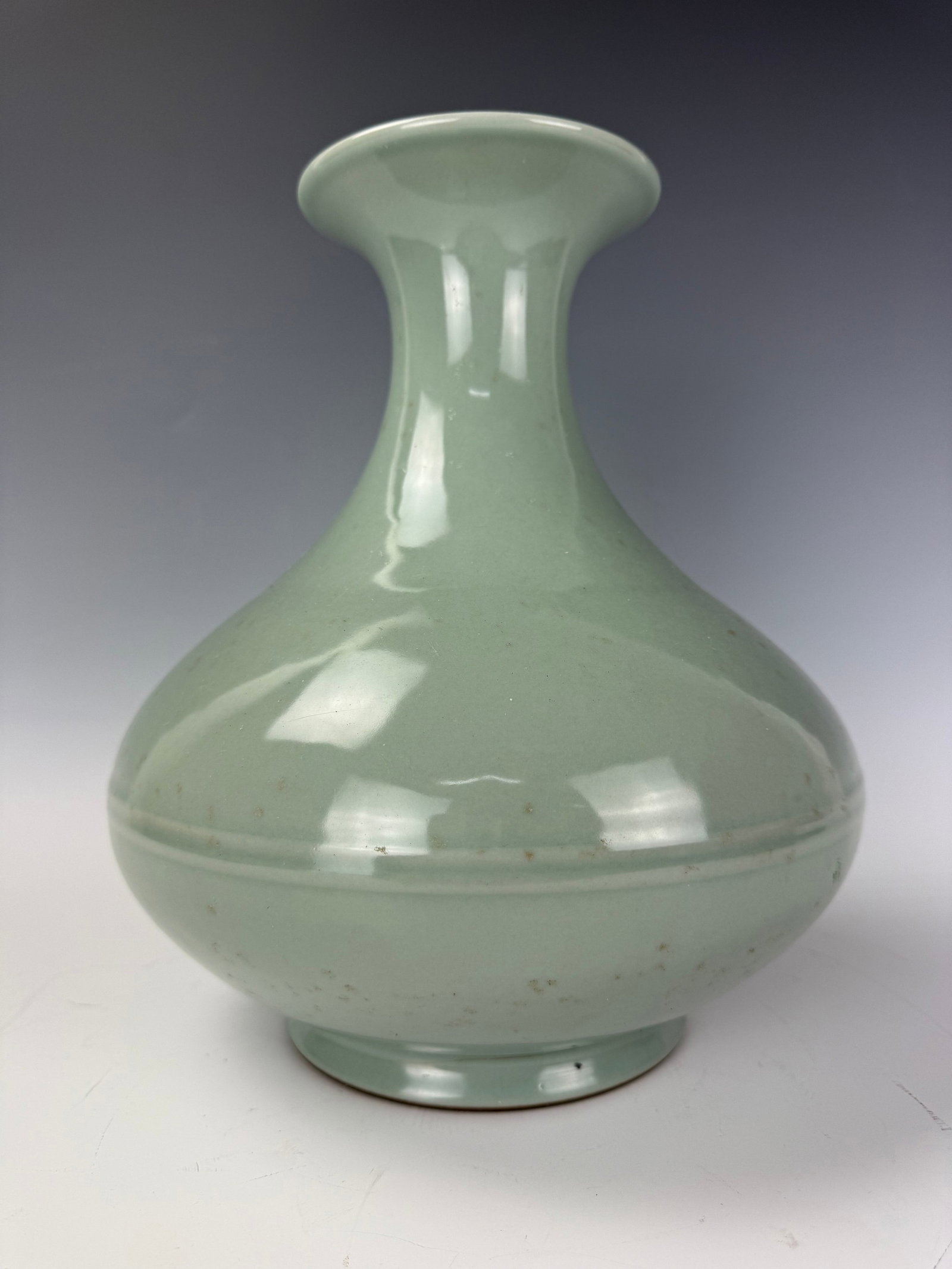 A Chinese Celadon Porcelain Vase: A Chinese Celadon Porcelain Vase,H 28 cm(11.3 in.). Preview from June 22nd to 26th from 1:00 PM TO 5:00 PM Eastern Time, Location: 15229 Display Court, Rockville, MD 20850.