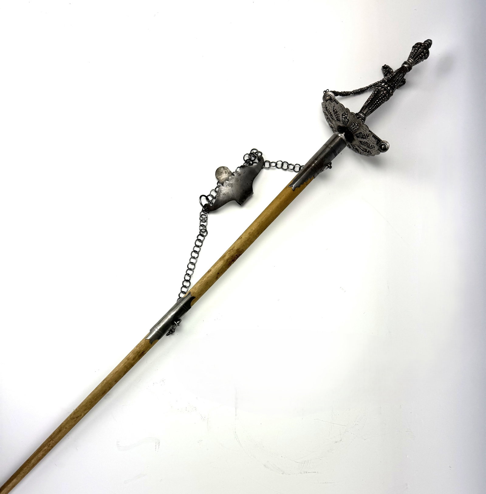 An Antique English Style Court Sword with Wood Box: An Antique English Style Court Sword with Wood Box, featuring a decorated metal hilt, a guard joined to the pommel by a chain, and a tapered scabbard. L 72.7 cm (28.6 in.) x W 10.8 cm (4.2 in.). Previ