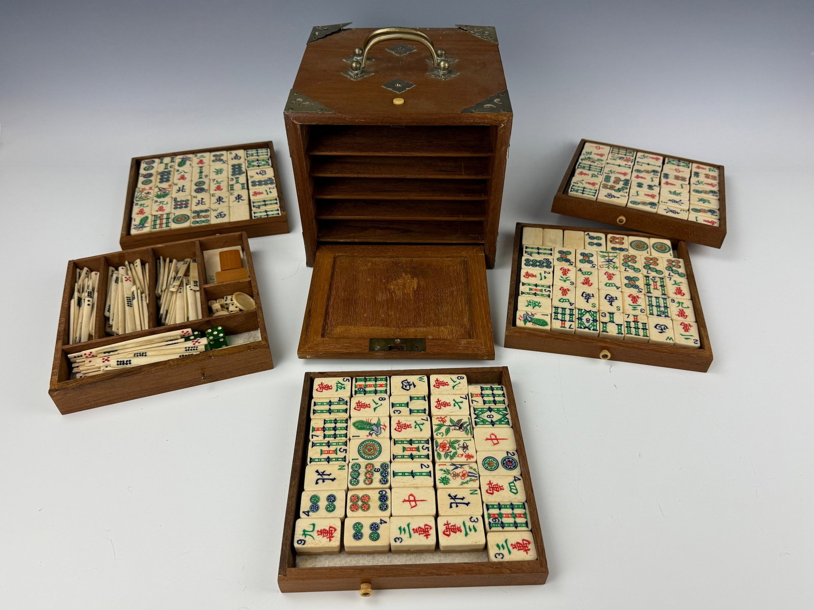 A Vintage Chinese Complete Mahjong Set: Complete Mahjong Set with Bone Tiles, Scoring Sticks, Dice, and Wooden Box. Box L 20 cm(7.9 in.) x W 20 cm(7.9 in.) x H 17 cm(6.7 in.). Preview from Aug 24th to 28th from 1:00 PM TO 5:00 PM Eastern Ti