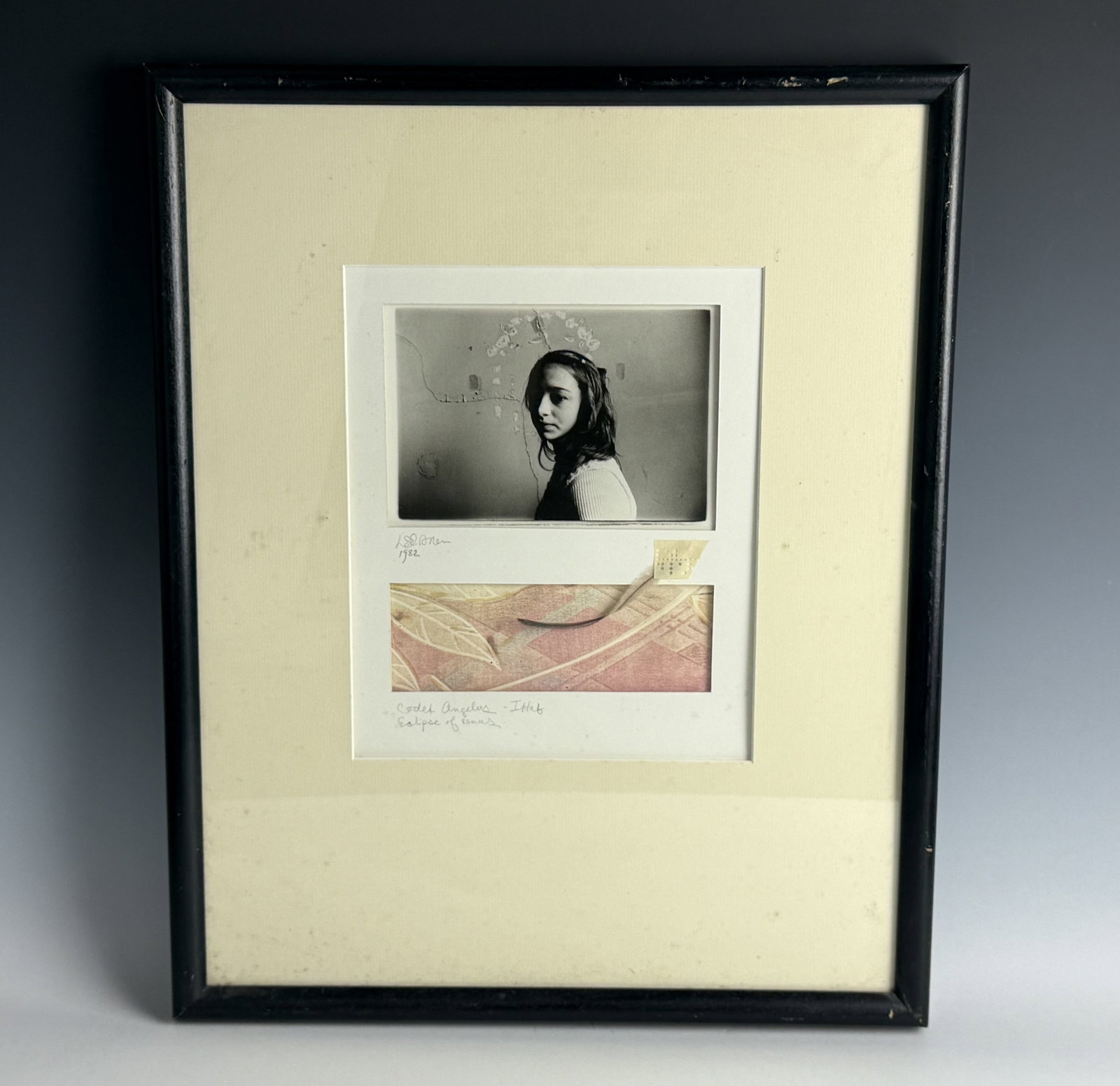 A Conceptual Artwork Featuring A Black White Portrait Paired with a Patterned Fabric: A Framed Conceptual Artwork Featuring A Black-and-White Portrait Paired with a Patterned Fabric Collage. Signed and dated 1982 with "Codex Angelus - IHHAF" and "Eclipse of Venus". H 27.4 cm(10.8 in.)