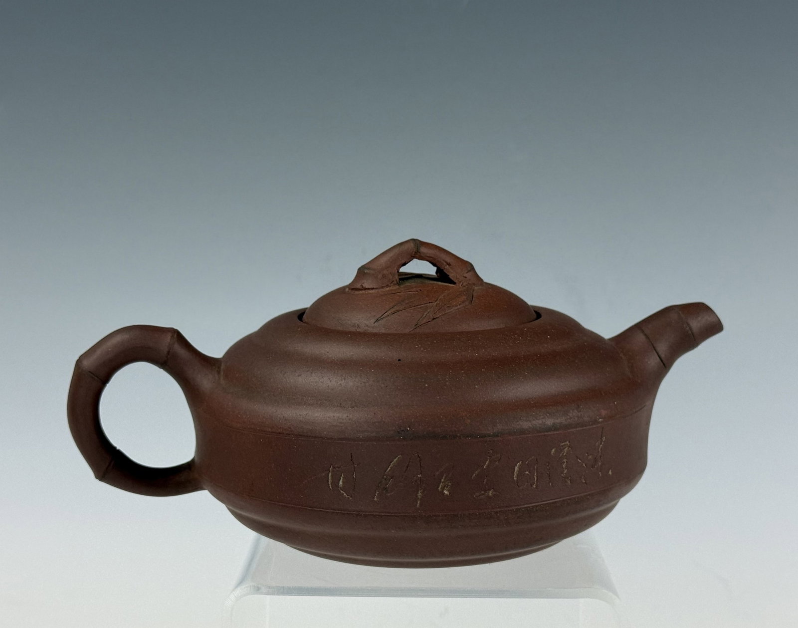 Yixing Zisha Teapot with Calligraphic Engraving: Yixing Zisha Teapot with Calligraphic Engraving. Size: L 19 cm(7.5 in.) x W 13 cm(5.1 in.) x H 8 cm(3.1 in.). Preview from Aug 24th to 28th from 1:00 PM TO 5:00 PM Eastern Time, Location: 15229