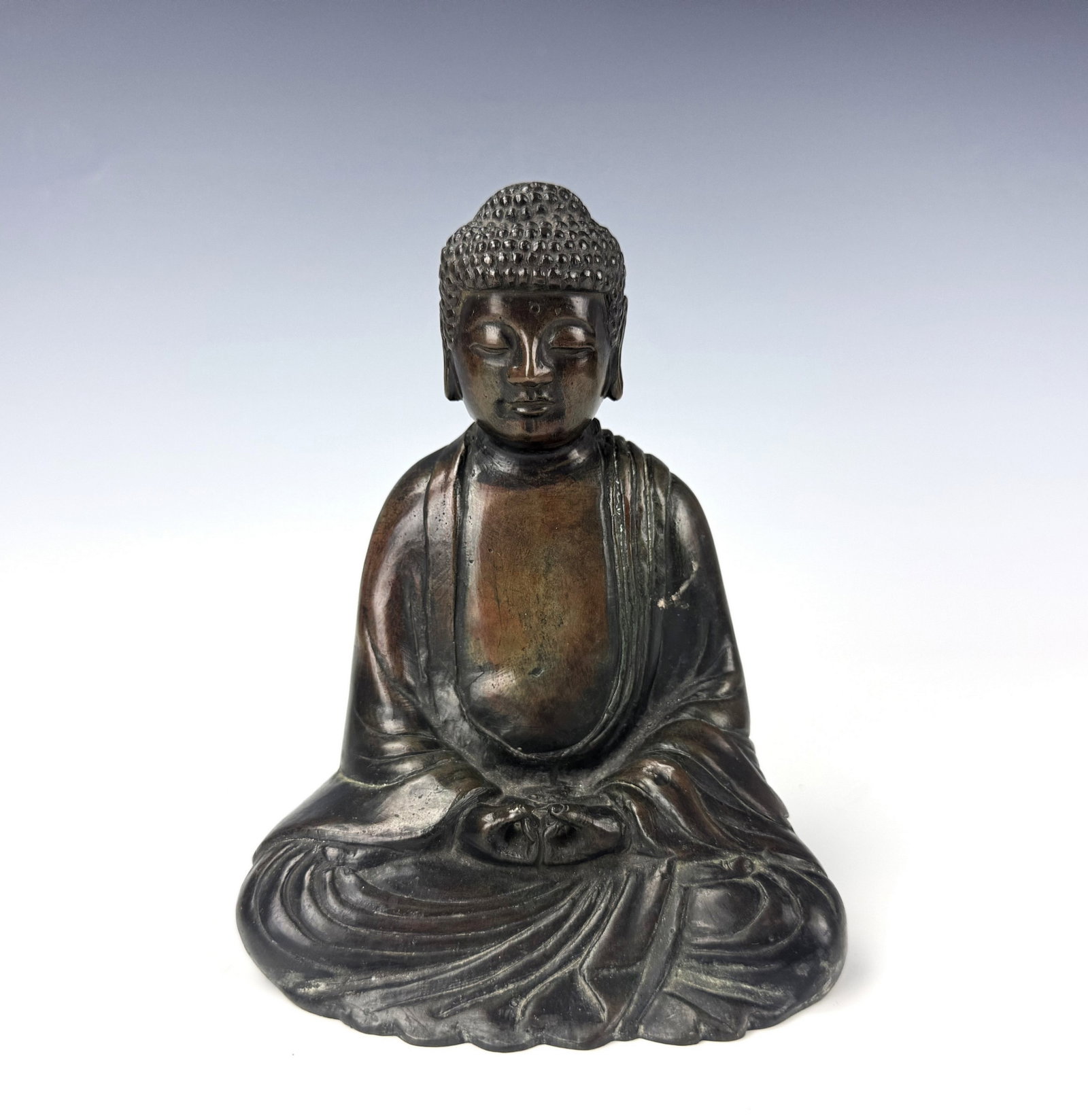 Chinese Bronze Statue of a Meditating Buddha: Chinese Bronze Statue of a Meditating Buddha. Dated late 19th century to early 20th century. H 15.7 cm (6.2 in.) x W 11 cm(4.3 in.). Preview from Aug 24th to 28th from 1:00 PM TO 5:00 PM Eastern Time,