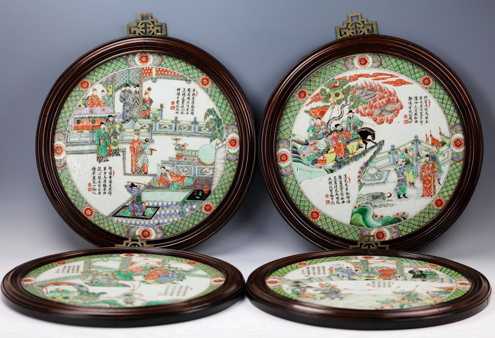 Set of Four Chinese Qing Dynasty Famille Rose Sanguo Story Porcelain Plaques: Four Famille Rose Plaques mounted as hanging panels; diameter: 46 cm (18 in.) with frames, 40 cm (16 in.) porcelain surface; 3 plaques in perfect condition and one plaque has a hair crack at the left 