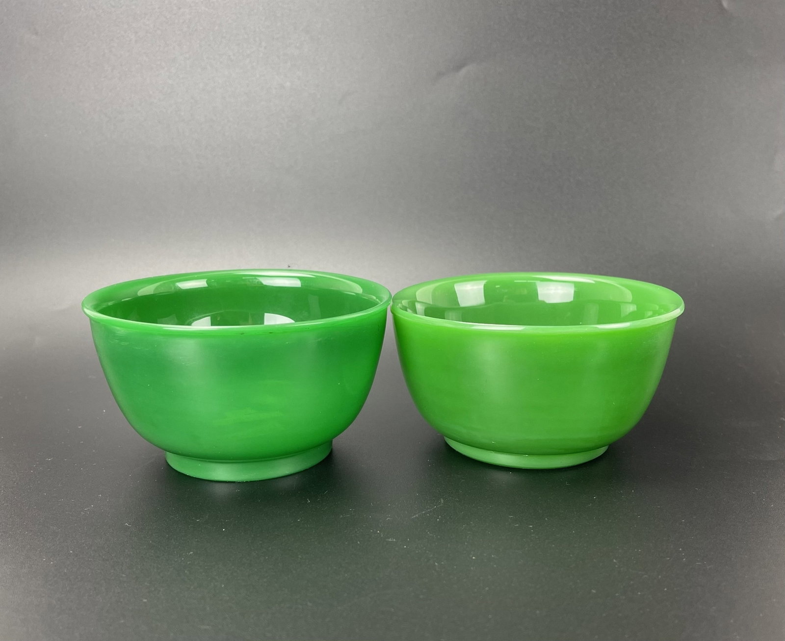 Two Vintage Chinese Green Peking Glass Bowls: Two Vintage Chinese Green Peking Glass Bowls. D 10.5 cm(4.1 in.) x H 5.5 cm(2.2 in.) x 2. Preview from Aug 24th to 28th from 1:00 PM TO 5:00 PM Eastern Time, Location: 15229 Display Court, Rockville, 