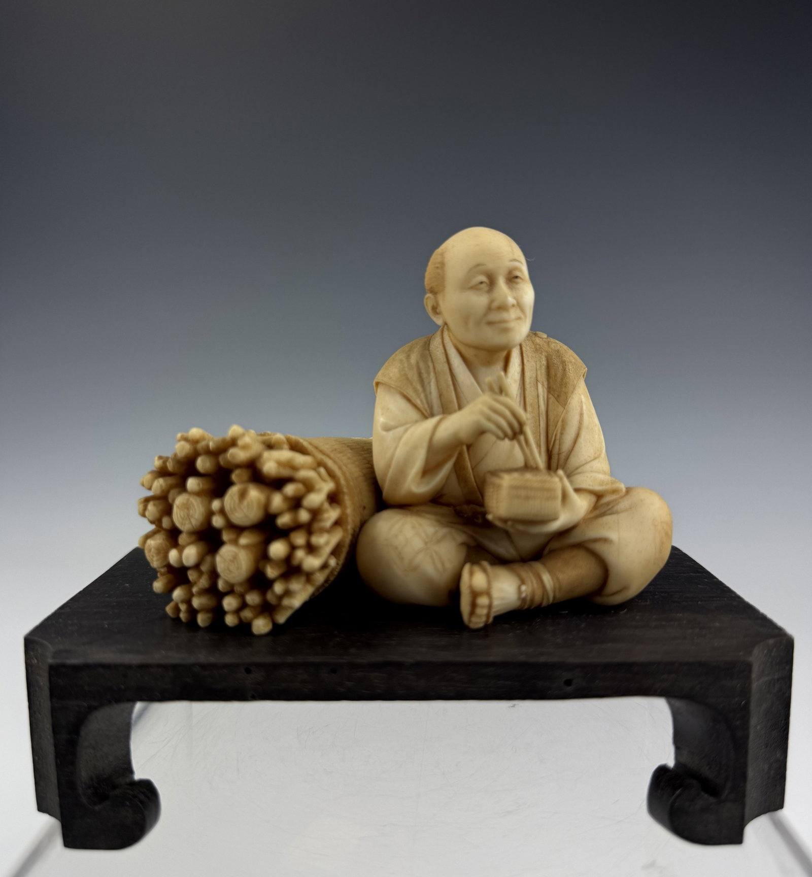 Japanese Carved Bone Netsuke Seated Figure with Sticks (1 of 3)