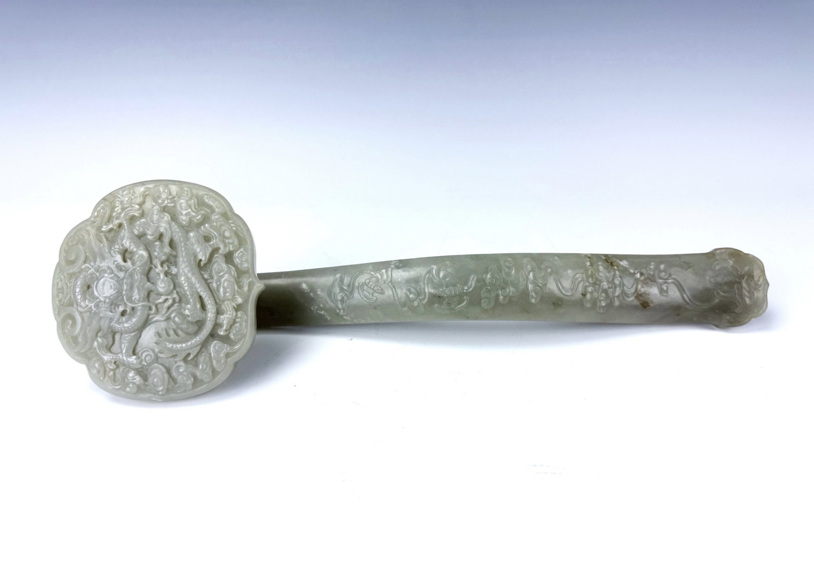 Chinese Jade Ruyi Scepter with Carved Dragons and Cloud Motifs: Chinese Jade Ruyi Scepter with Carved Dragons and Cloud Motifs. L 36 cm(14.2 in.) x W 11 cm(4.3 in.) x H 6 cm(2.4 in.). Preview from Aug 24th to 28th from 1:00 PM TO 5:00 PM Eastern Time, Location: 15