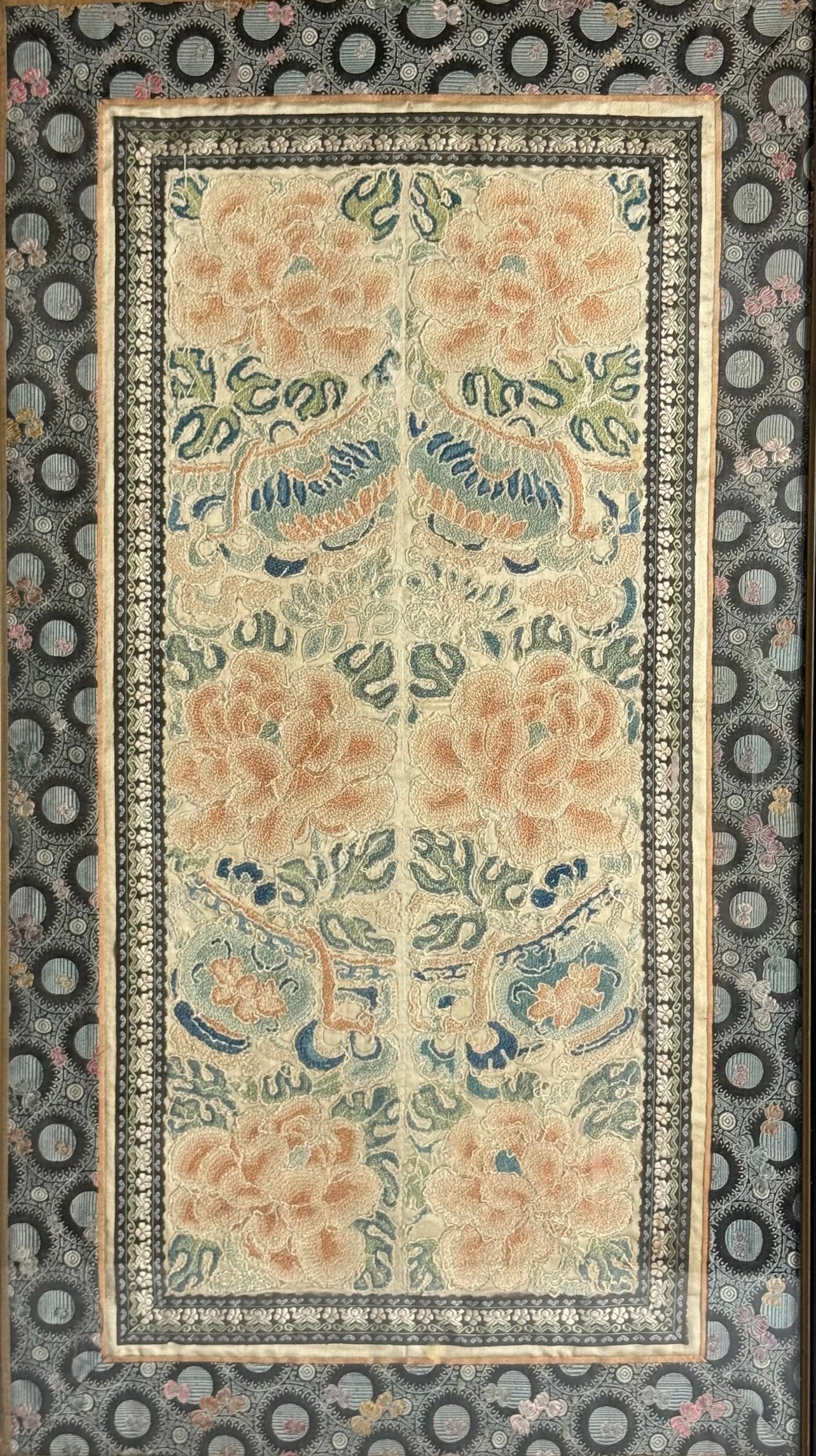An Antique Chinese Silk Textile with Symmetrical Embroidered Patterns: An antique Chinese silk textile panel featuring symmetrical embroidered floral patterns and large peony blossoms. H 63 cm(24.8 in) x W 34 cm(13.4 in.), Frame H 67 cm(26.3 in.) x W 38.4 cm(15.1 in.). P