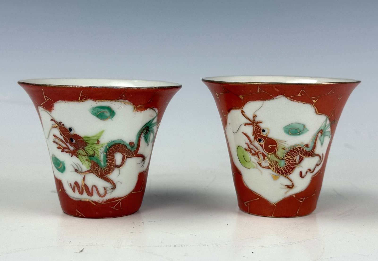 Pair of Chinese Red Ground Porcelain Cups with Zhanghongyuan Mark: Pair of Chinese Red Ground Porcelain Cups with Hand Painted Dragons. D 7.5 cm(3 in.) x H 5.5 cm(2.2 in.). Preview from Aug 24th to 28th from 1:00 PM TO 5:00 PM Eastern Time, Location: 15229 Display Co